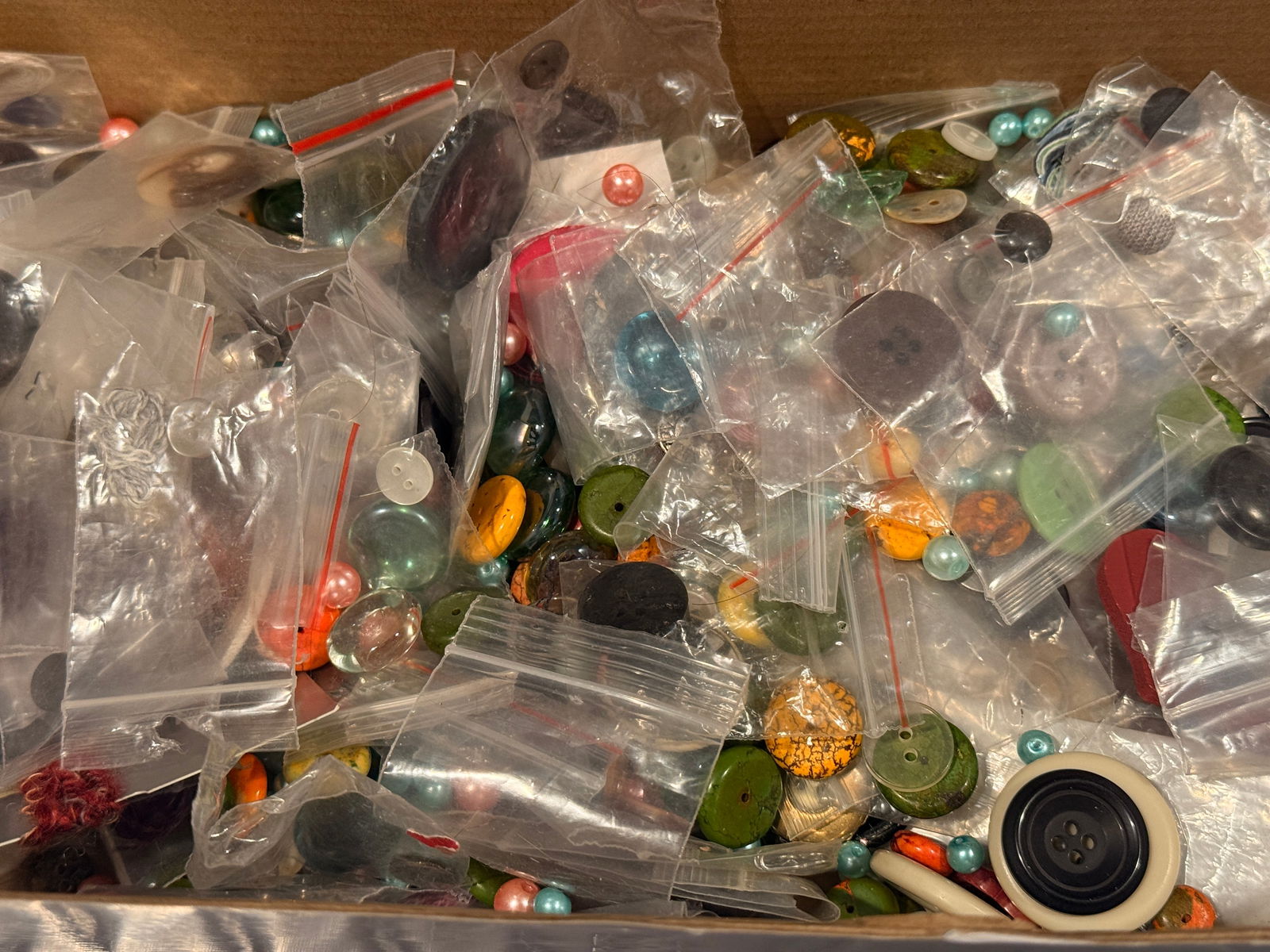 Mixed Vintage & Modern Button & Marble Assortment Lot (11 oz): A mixed lot of vintage and contemporary buttons and marbles totaling approximately 11 ounces. Includes plastic, wood, shell, and resin components suitable for crafting and sewing projects.