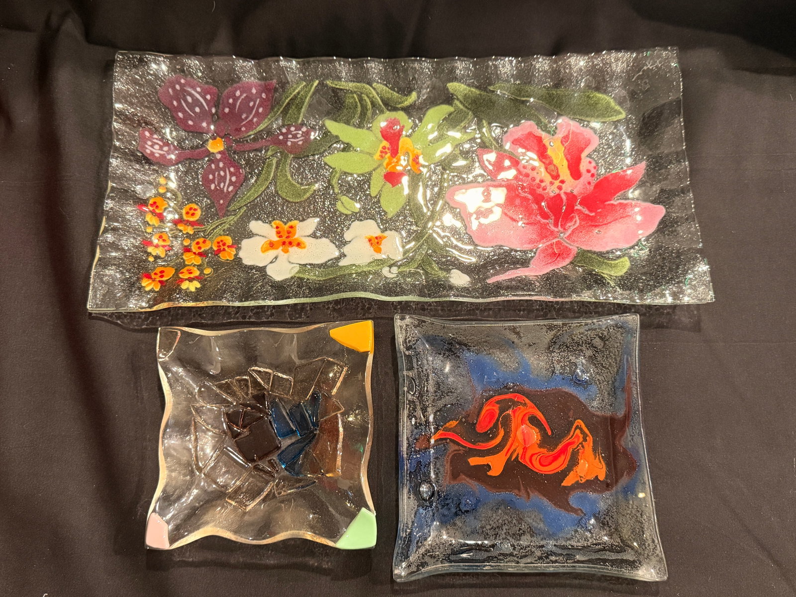 Three Handmade Fused Glass Trays: Group of three handmade fused art glass trays, floral and abstract designs in varied sizes. larger - 14"x6.5" - medium - 5.5"x5.5" - smaller - 4.75"x4.75"