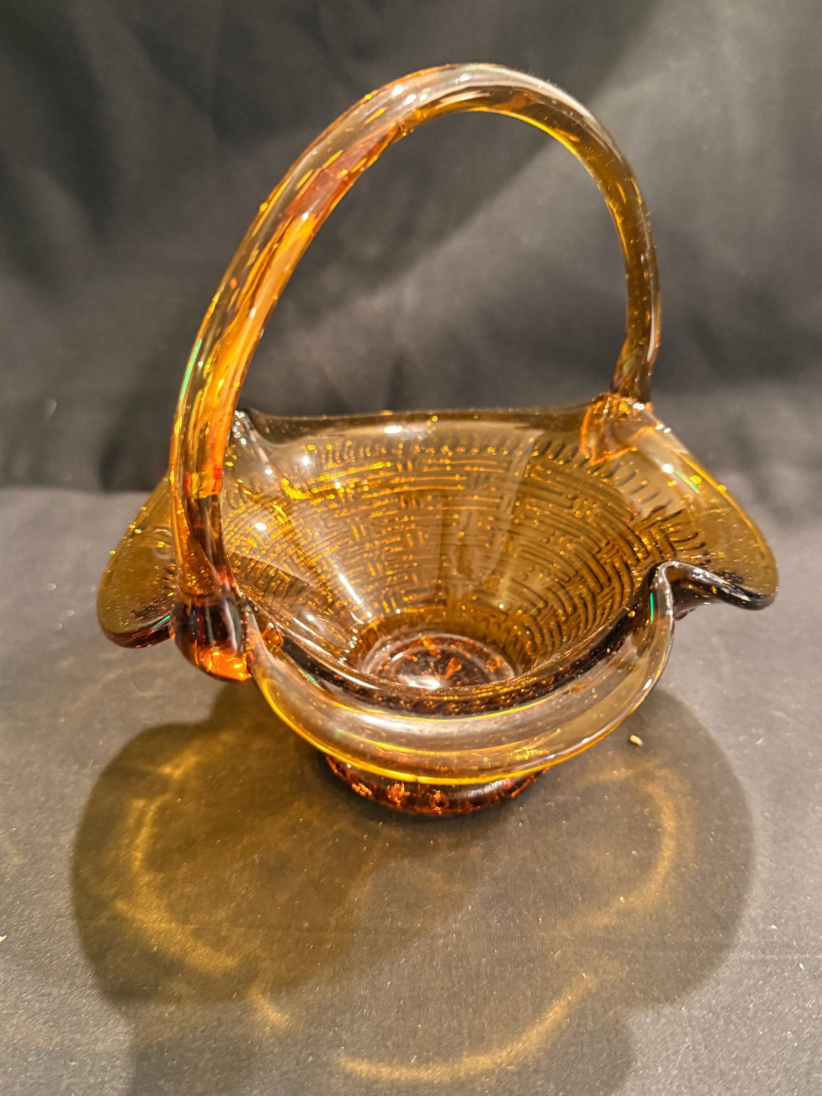 Amber Pressed Glass Basket with Handle: Amber pressed glass basket with applied handle and flared rim, decorative footed base. 6" x 5.75" x 5.25"