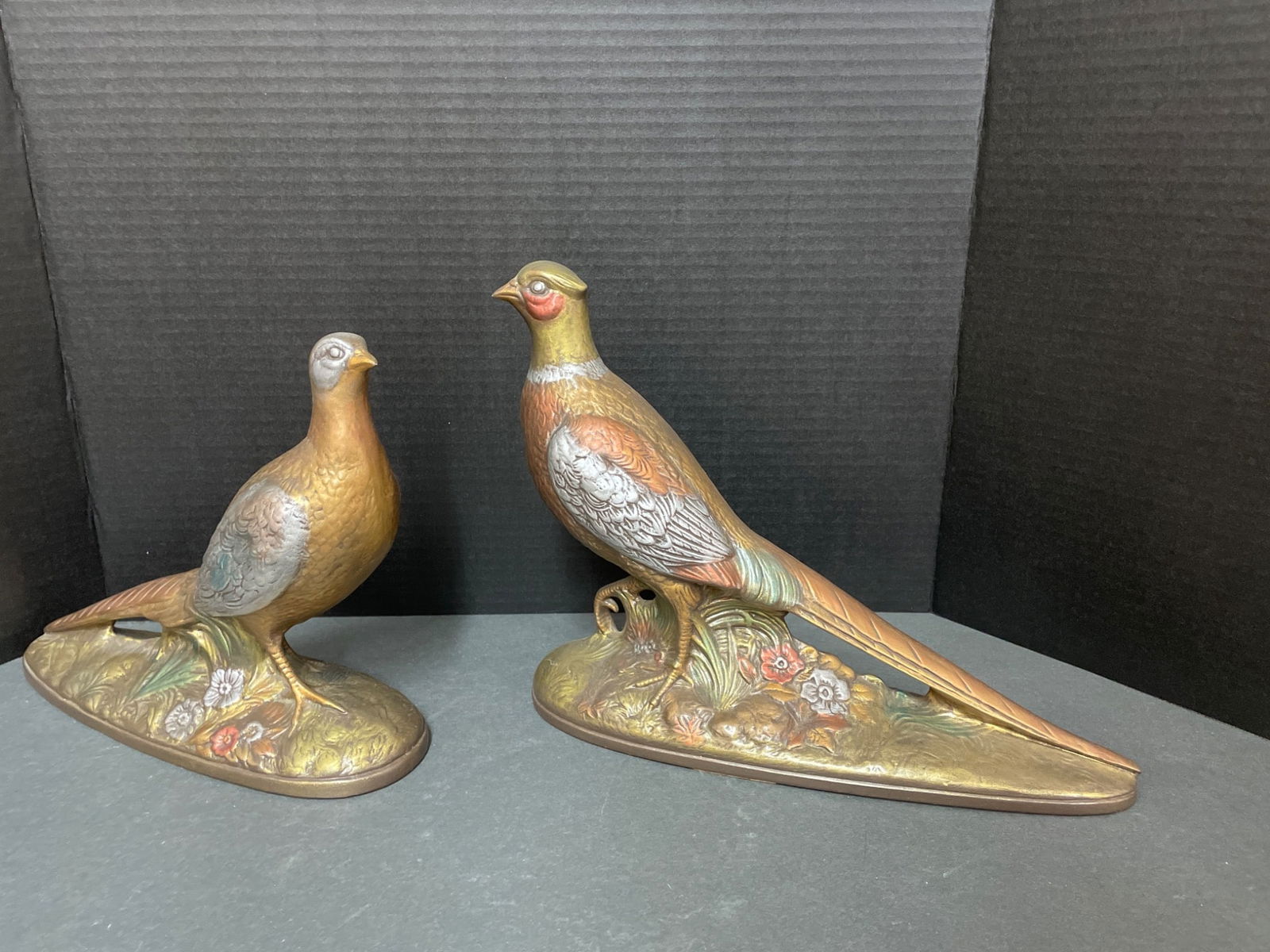 Holland Mold Ceramic Pheasant Figurines: This lot includes two painted ceramic pheasant figurines stamped 'Holland Mold' on the base. Each figure depicts a pheasant with detailed floral designs on the base. The approximate dimensions show