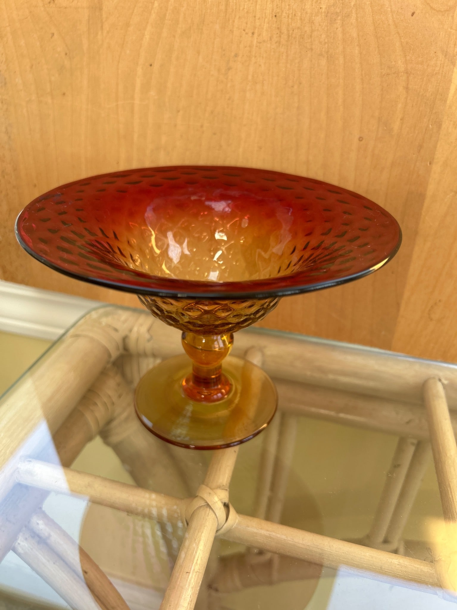 Amberina Glass Compote Dish with Diamond Texture Design: This is an Amberina glass compote dish featuring a textured diamond pattern. It transitions from amber at the base to red at the rim. The piece is likely hand-blown, based on its craftsmanship, and