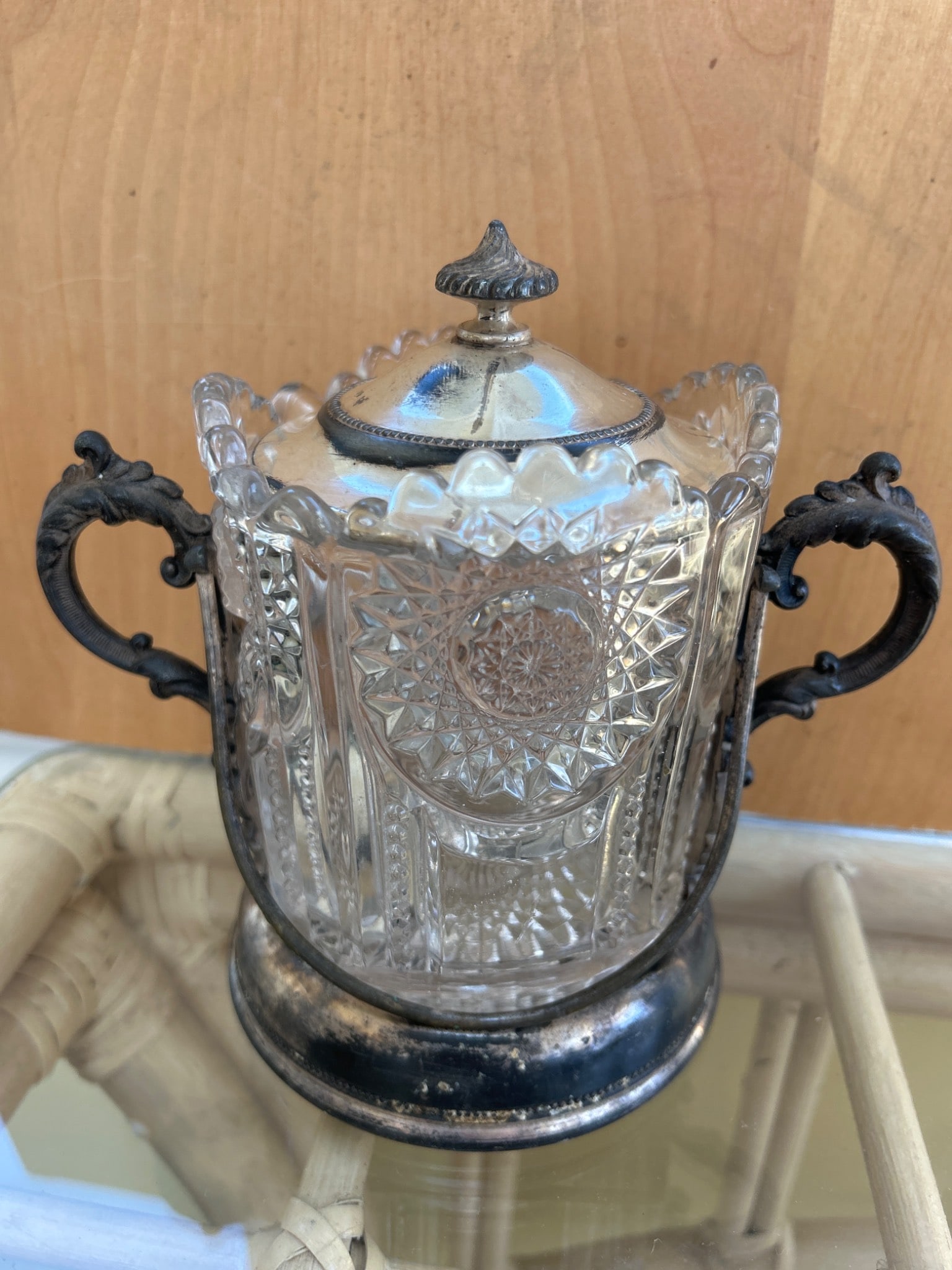 Glass And Silver-Plated Sugar Bowl With Lid, Marked 'LM Silver Co., Quadruple Plate, 33': This is a glass sugar bowl with a silver-plated lid and base. The base is marked 'LM Silver Co., Quadruple Plate, 33.' The glass body features a decorative pressed pattern. The item measures