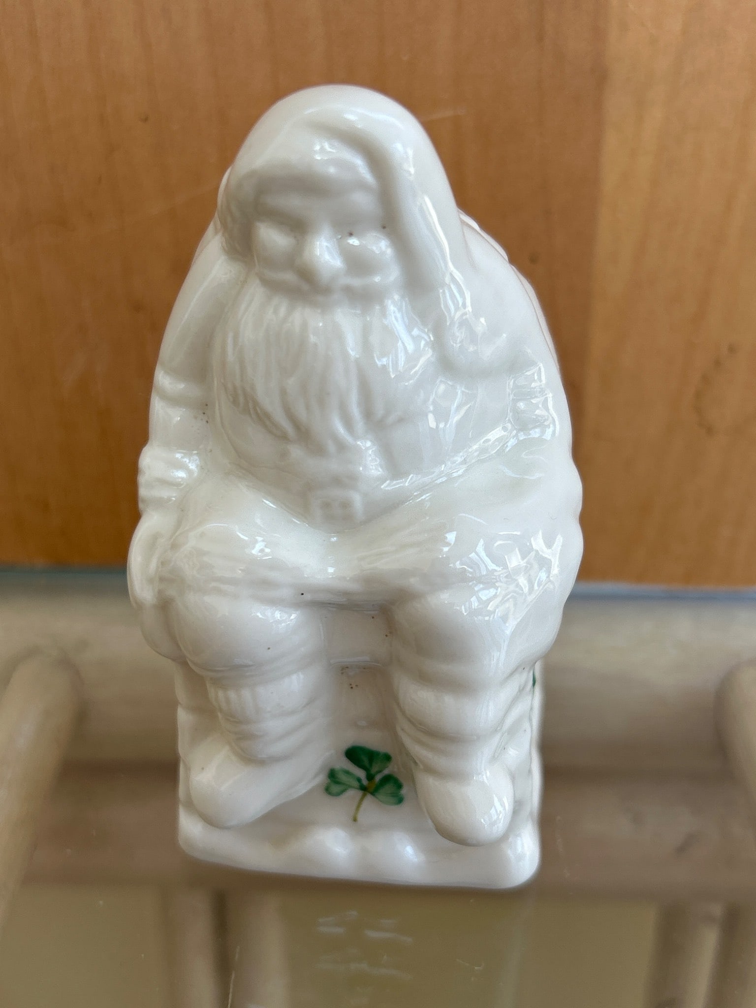 Belleek Santa in Chimney Salt Shaker, 2,087: A collectible Belleek Santa in Chimney porcelain salt shaker produced in Fermanagh, Ireland. Marked with the Belleek logo and stamped '2087' on the underside. The piece features a sitting Santa on a c