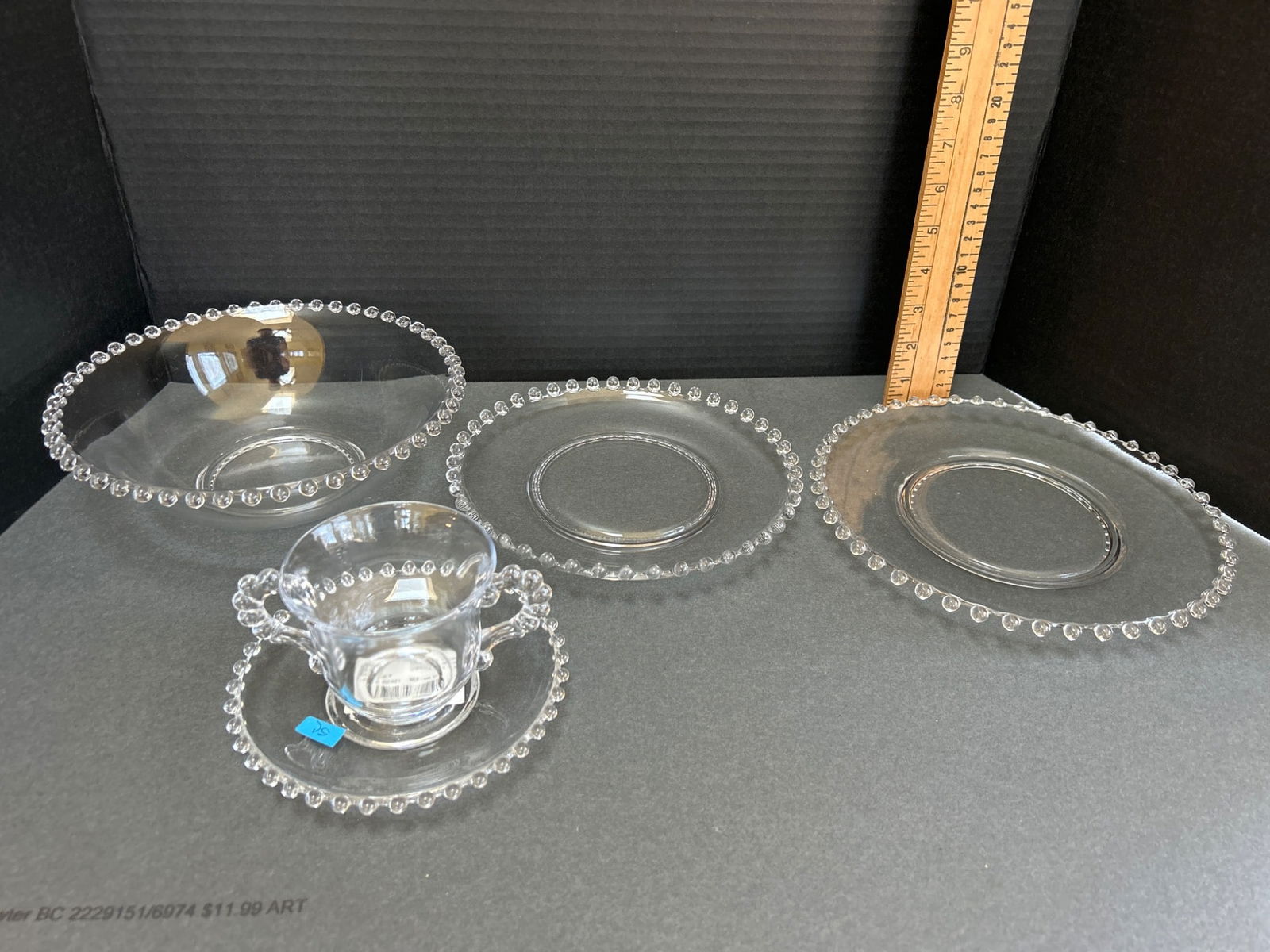 Imperial Glass Candlewick Clear Glass Dinnerware Set: This lot includes an assortment of clear glass dinnerware from the Imperial Glass Candlewick collection. Identified item details based on labeling: one saucer marked with model 31094A. Pieces include