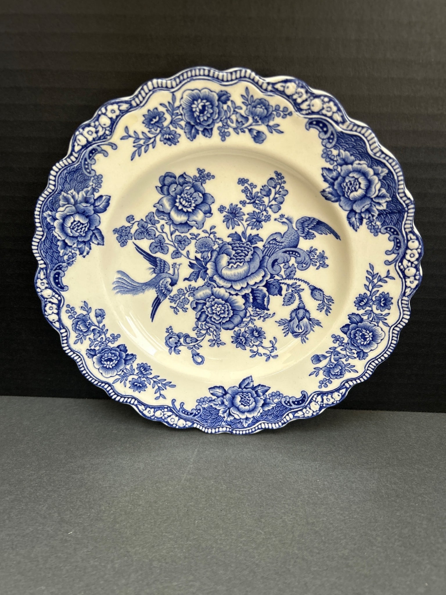Crown Ducal Bristol Blue Transferware Plate with Registration Number 762055: This is a Crown Ducal plate from England, featuring blue transferware in the 'Bristol' pattern. The plate includes floral and bird motifs, with a scalloped edge. The back is stamped with the mark