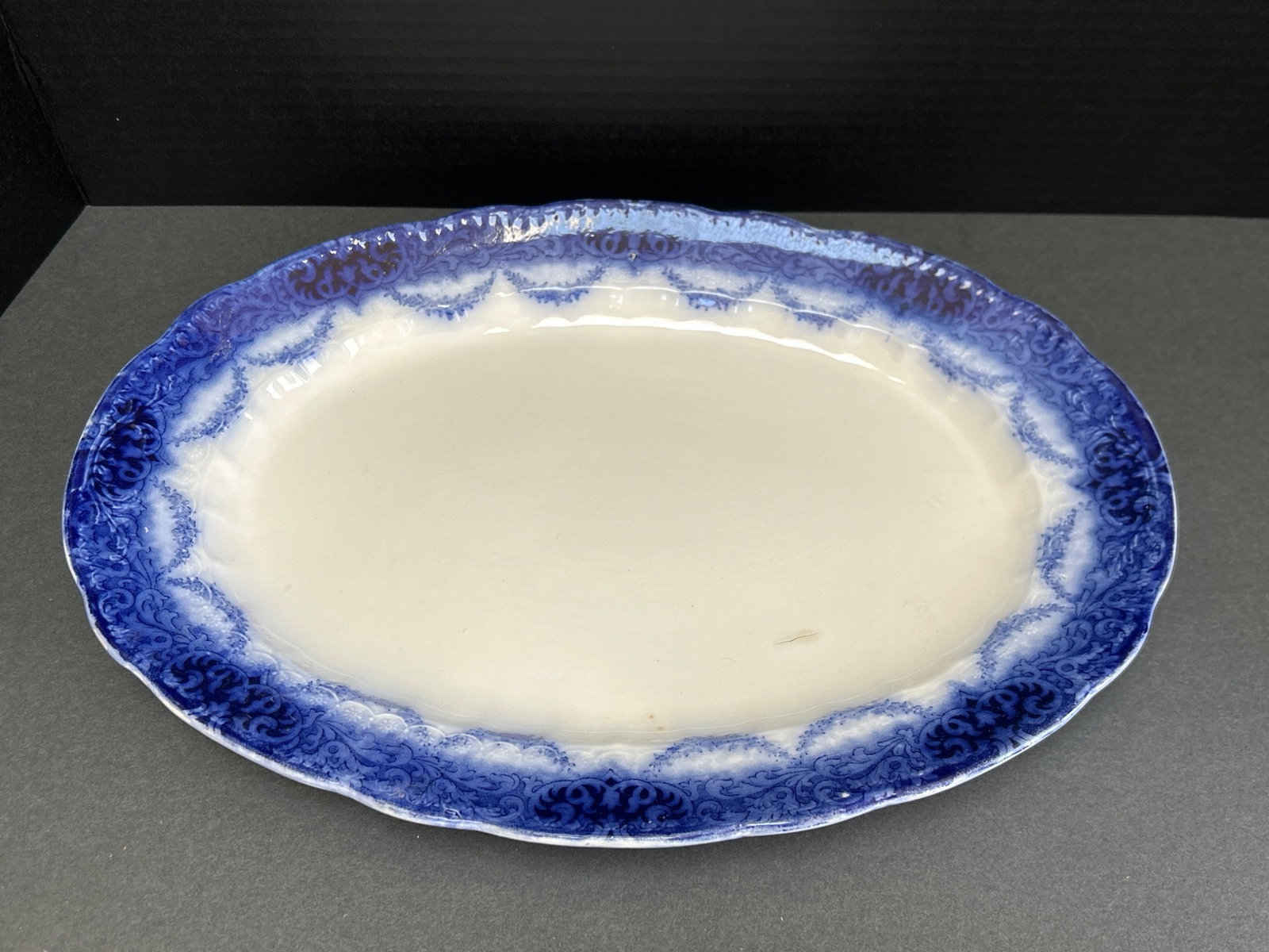 Alfred Meakin Royal Semi-Porcelain Oval Serving Platter, England: An oval serving platter produced by Alfred Meakin, England. The platter is marked with the Alfred Meakin makers' mark and labeled as 'Royal Semi-Porcelain.' It features a blue floral border design and