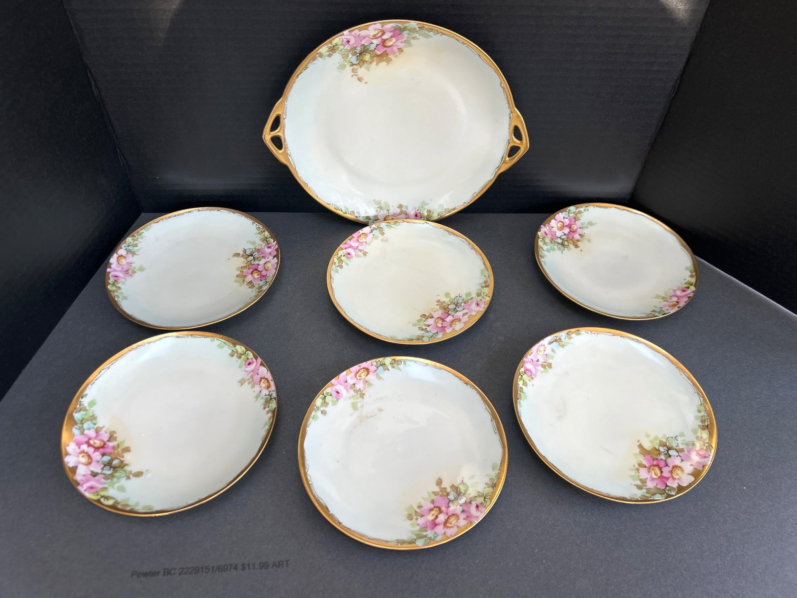 J&C Bavaria Porcelain Dessert Plates with Matching Serving Dish, 7-Piece Set: This lot includes a 7-piece porcelain dessert set from J&C Bavaria, marked with the crossed flowers hallmark. The set comprises six dessert plates (approximately 7 inches in diameter) and one matching