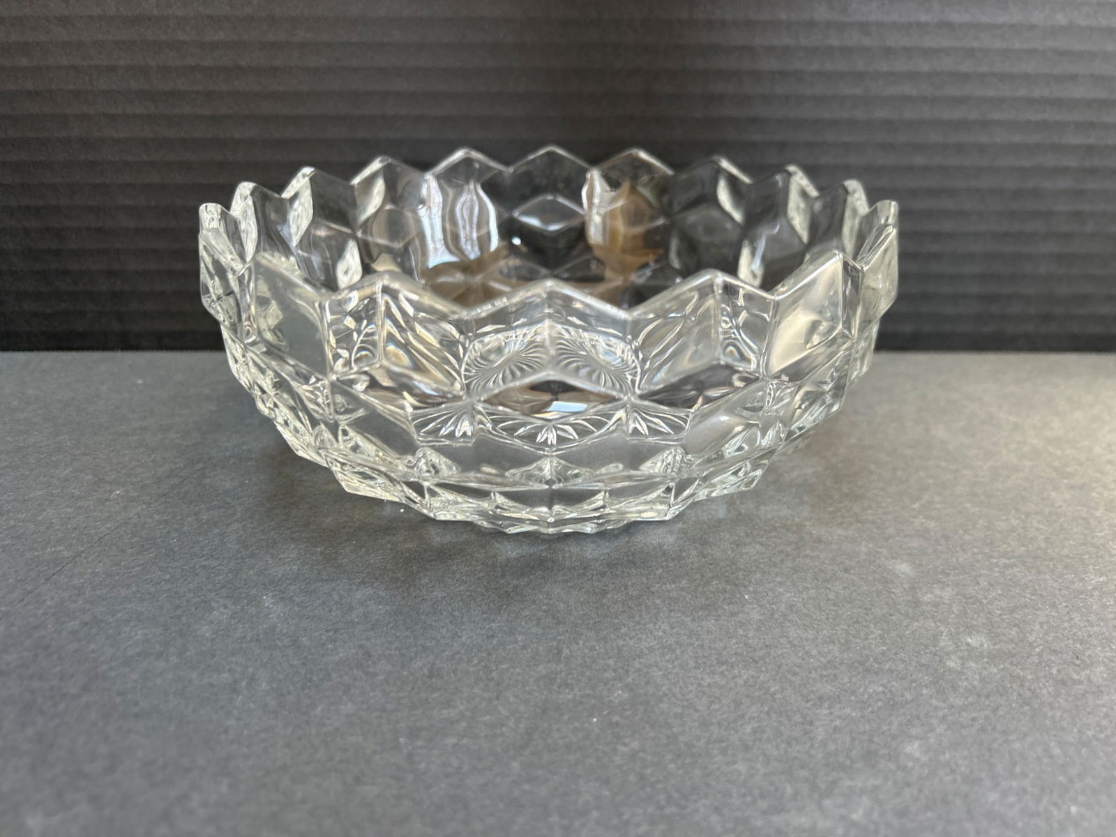 Clear Pressed Glass Bowl with Geometric Pattern, 6-Inch Diameter: A clear pressed glass bowl featuring a geometric pattern with a starburst design at the base. The bowl has a 6-inch diameter and an approximate height of 2.5 inches. Exact manufacturer and year of