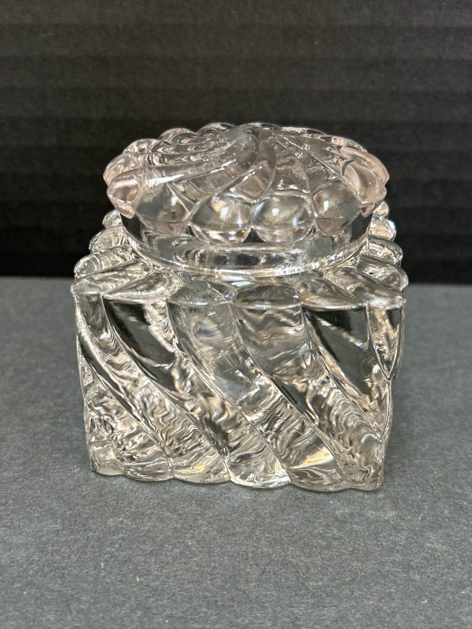 Cut Glass Inkwell with Detachable Lid and Decorative Pattern: Cut glass inkwell featuring a square base and a detachable lid. The inkwell measures approximately 2.5 inches in height, as shown next to a ruler for scale. The ornate design includes swirled and