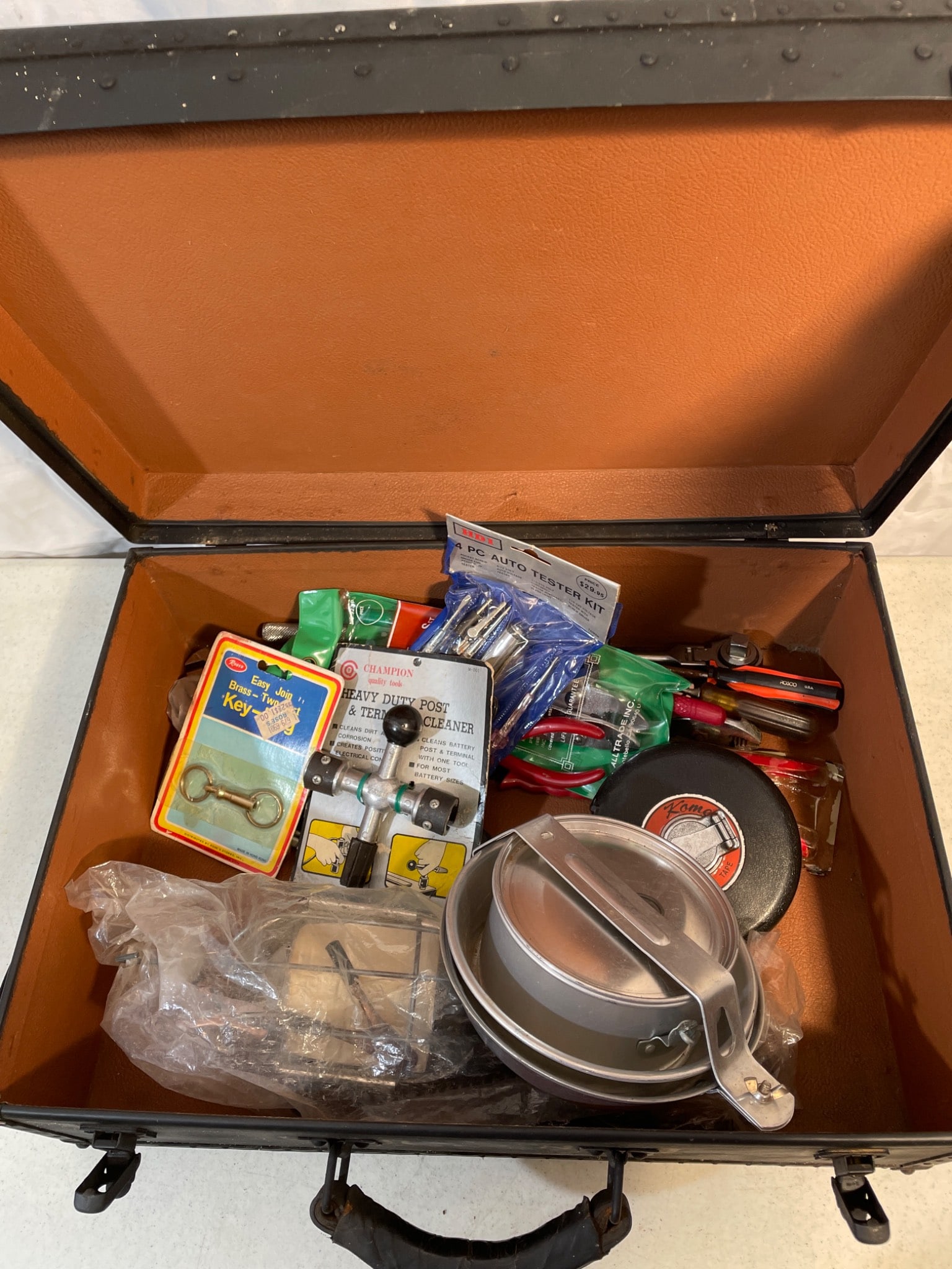 Metal Tool Case with Assorted Tools and Accessories: This lot includes a sturdy black metal tool case containing various tools and accessories. Items include pliers, wrenches, screwdrivers, and various components. The outer case shows signs of wear but 