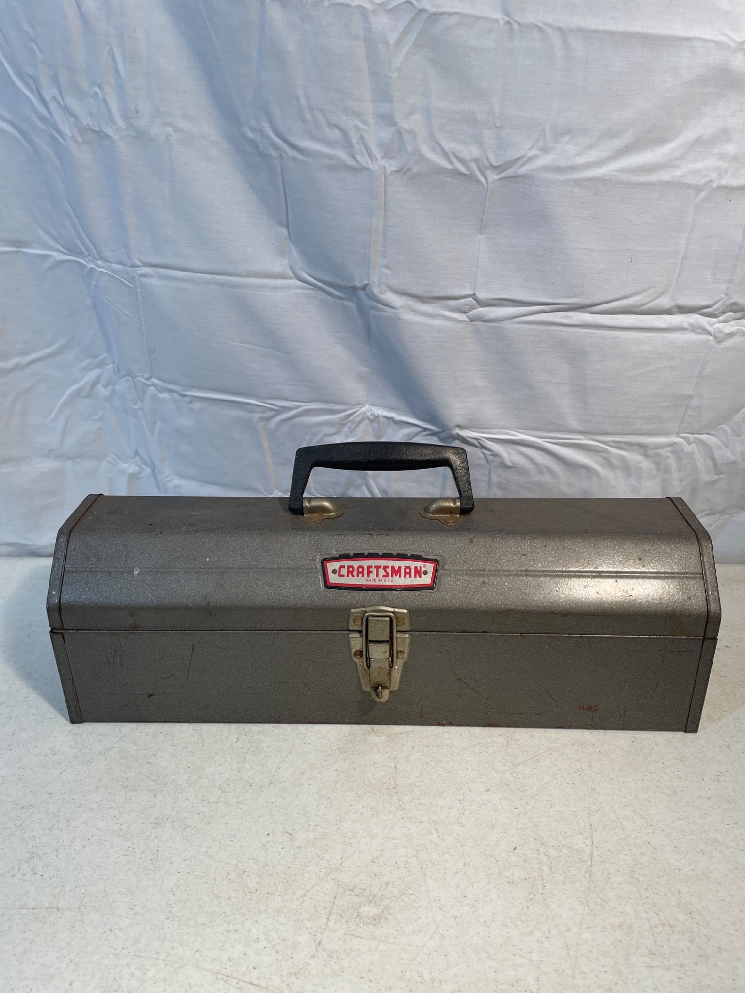 Craftsman Metal Toolbox With Assorted Tools: This lot includes a Craftsman metal toolbox with a latch closure and handle on the lid. The box contains various hand tools and accessories, such as wrenches, pliers, screwdrivers, and miscellaneous s