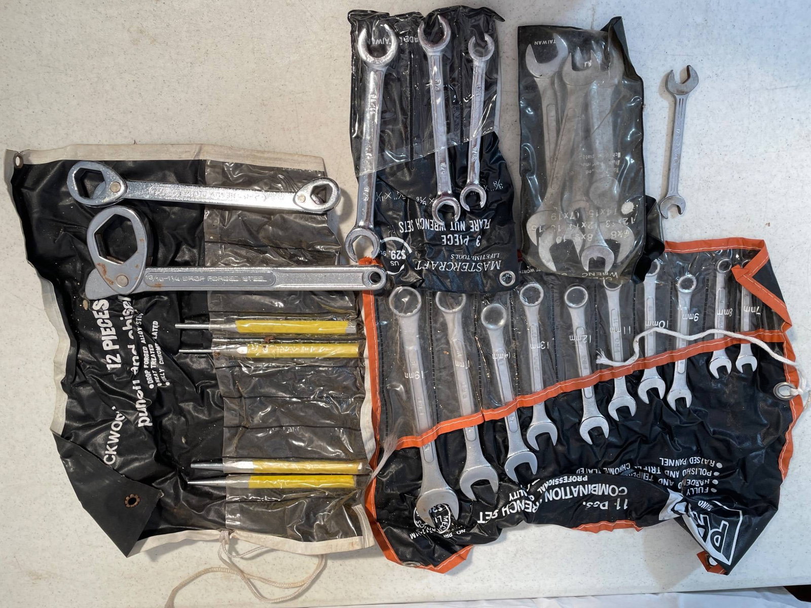 Wrench Sets by Pro-Aid, Blackwood, and Mastercraft: This collection includes multiple wrench sets from brands such as Pro-Aid, Blackwood, and Mastercraft. The sets include a 12-piece Blackwood punch and chisel set, an 11-piece Pro-Aid combination wrenc