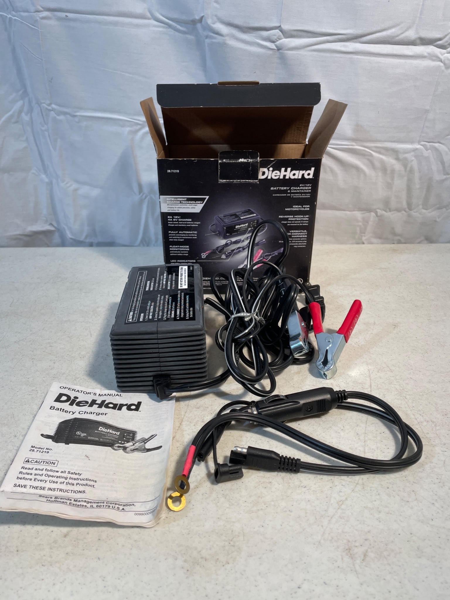 DieHard Battery Charger/Maintainer with Original Packaging and Manual: DieHard battery charger/maintainer for 12V batteries. Includes the main charger unit, power cords, battery clips, and user manual. Comes with original packaging. Untested, but appears to be in good