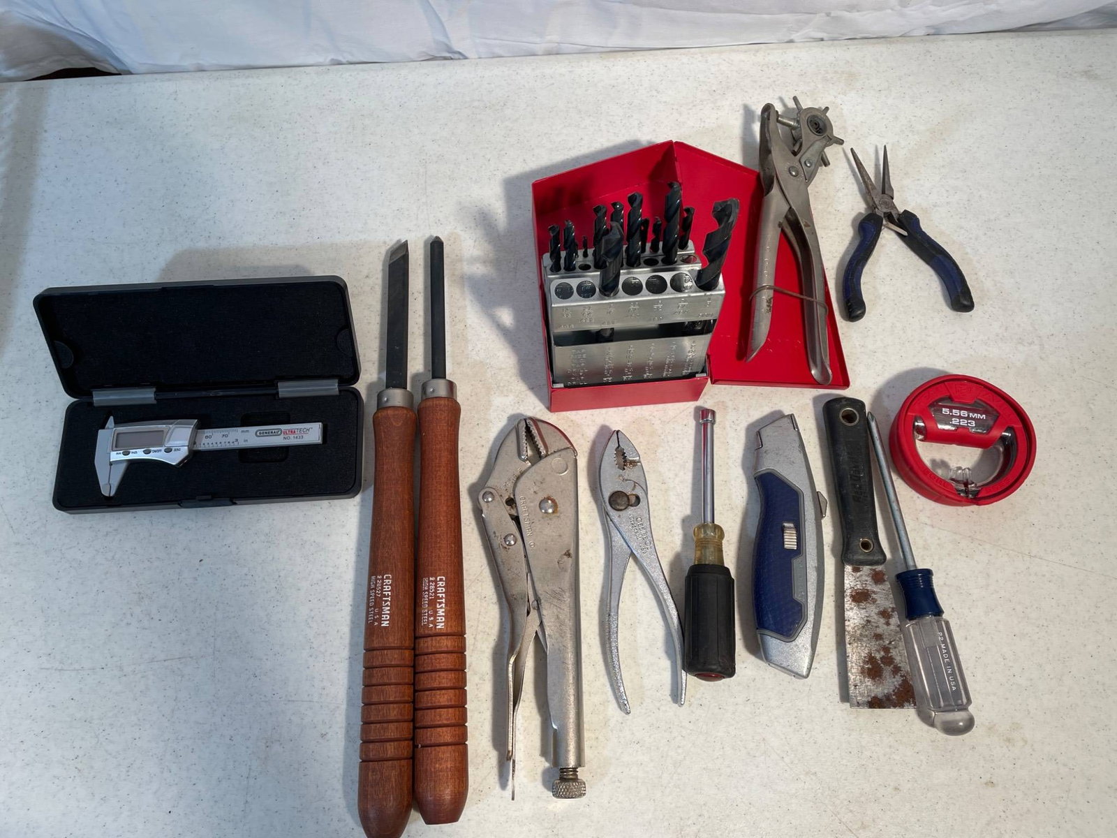 Tools Including Turning Chisels, Caliper, and Drill Bit Set: Collection consists of various tools, including a digital caliper with case, two Crown Tools turning chisels, locking pliers, a six-piece drill bit set with red metal storage case, hole punch pliers,