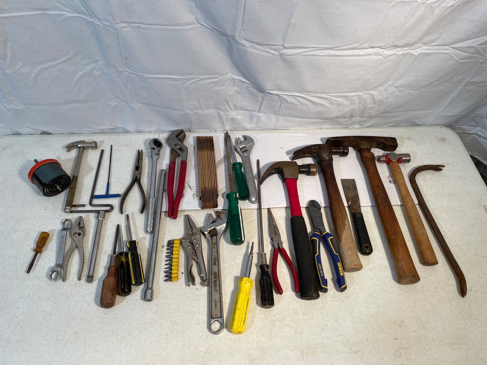Tool Lot Including Hammers, Screwdrivers, Pliers, and Wrenches: Hand tools consisting of multiple items, including claw hammers, screwdrivers of various sizes, pliers, adjustable wrenches, Allen wrenches, a crowbar, and more. Includes tools with wooden and plastic