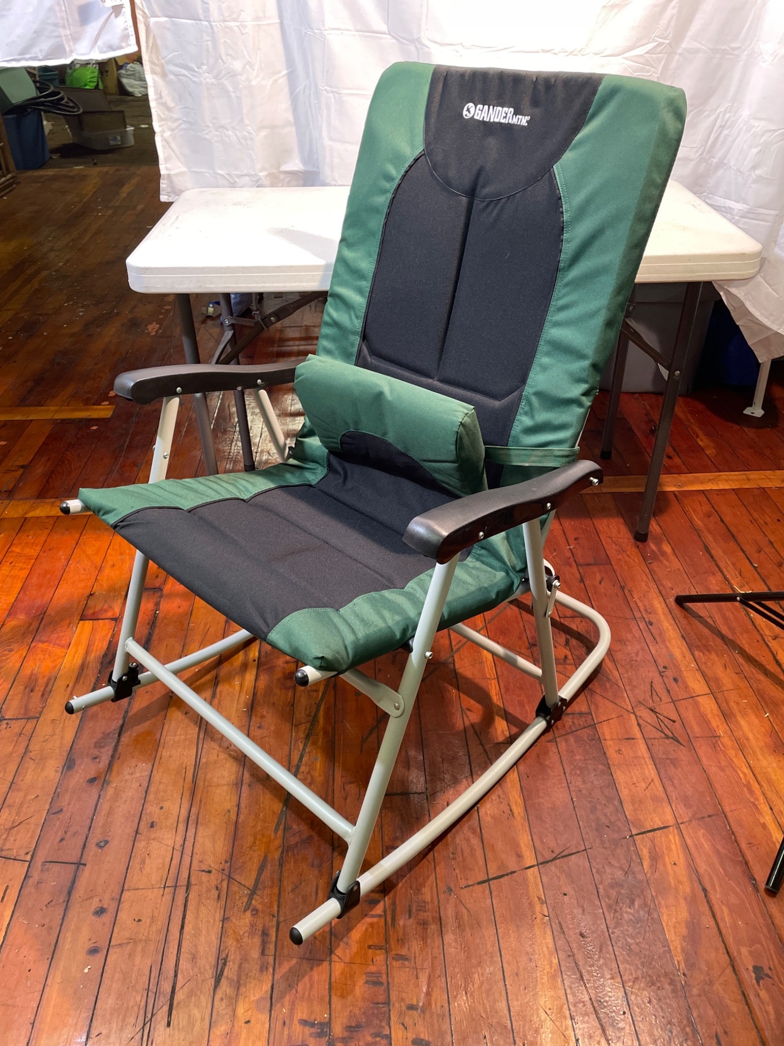 Gander Mountain Reclining Chair With Metal Frame and Fabric Upholstery: This is a reclining chair from Gander Mountain, featuring a sturdy metal frame and green fabric upholstery with black accents. The chair includes a detachable lumbar support cushion, enhancing