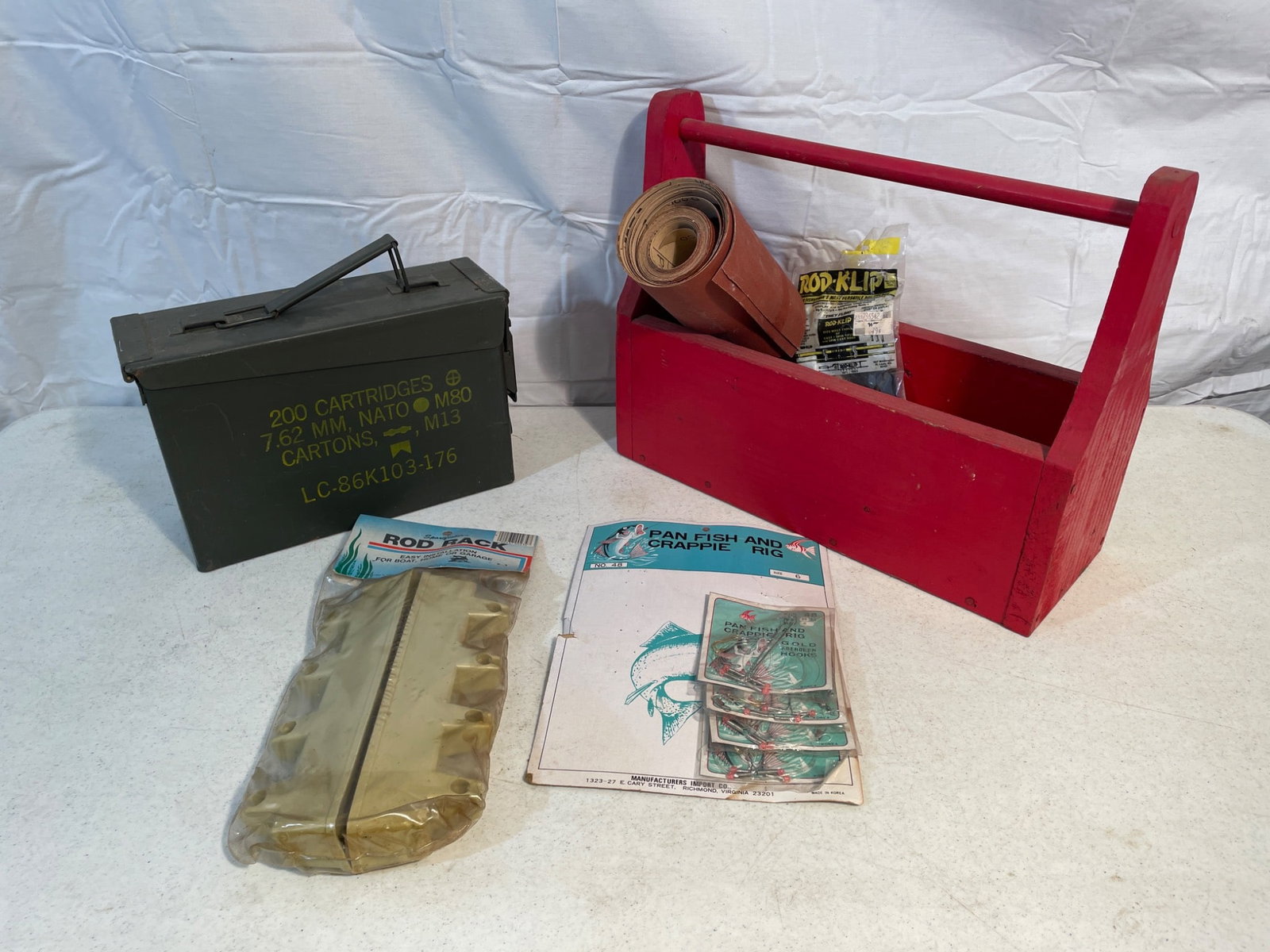 Items Including M80 Ammo Box, Fishing Gear, and 3M Sandpaper: This lot includes a wooden toolbox, a metal M80 ammunition box designed for 200 cartridges of 7.62mm NATO, assorted 3M sandpaper rolls and sheets (P220 grit, model 3M241 Production Resinite), fishing 