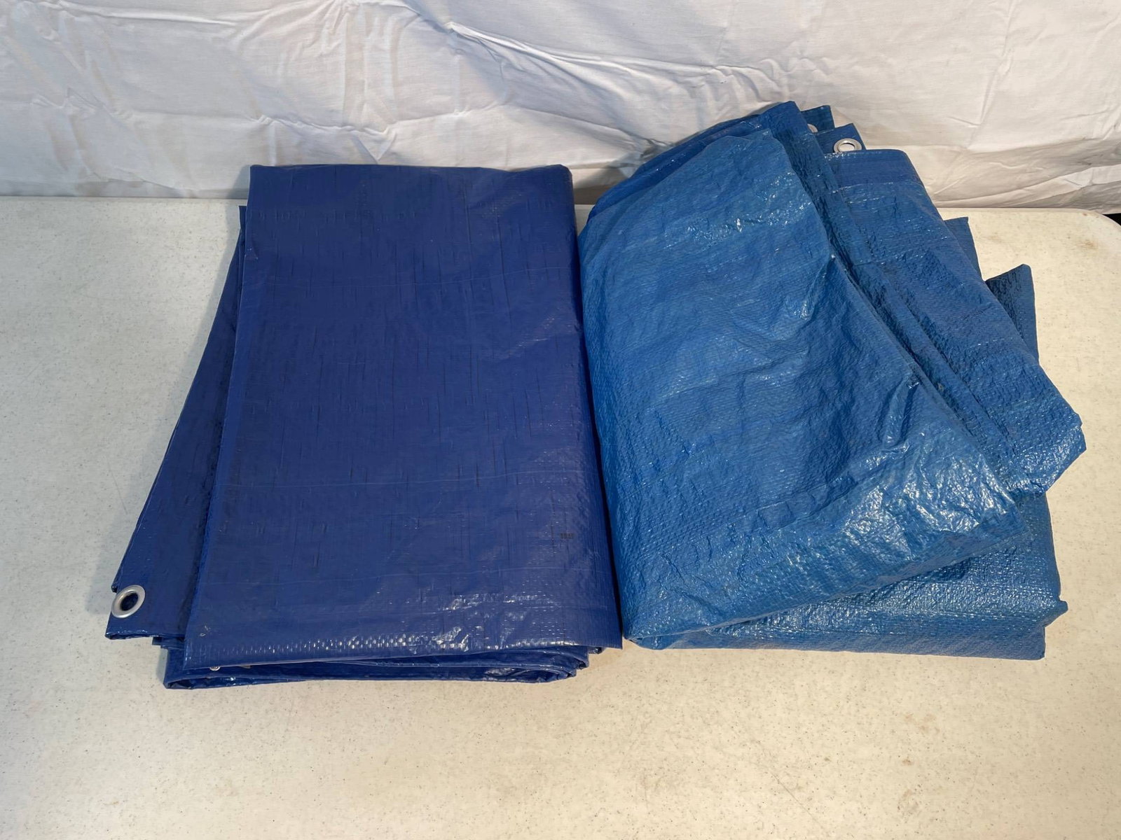 Durawork 6x8 Ft Blue Tarp, Waterproof, Multi-Purpose: This listing features a Durawork 6x8 ft blue waterproof tarp, constructed with durable materials for multi-purpose use. The tarp includes reinforced grommets for secure fastening and is labeled as