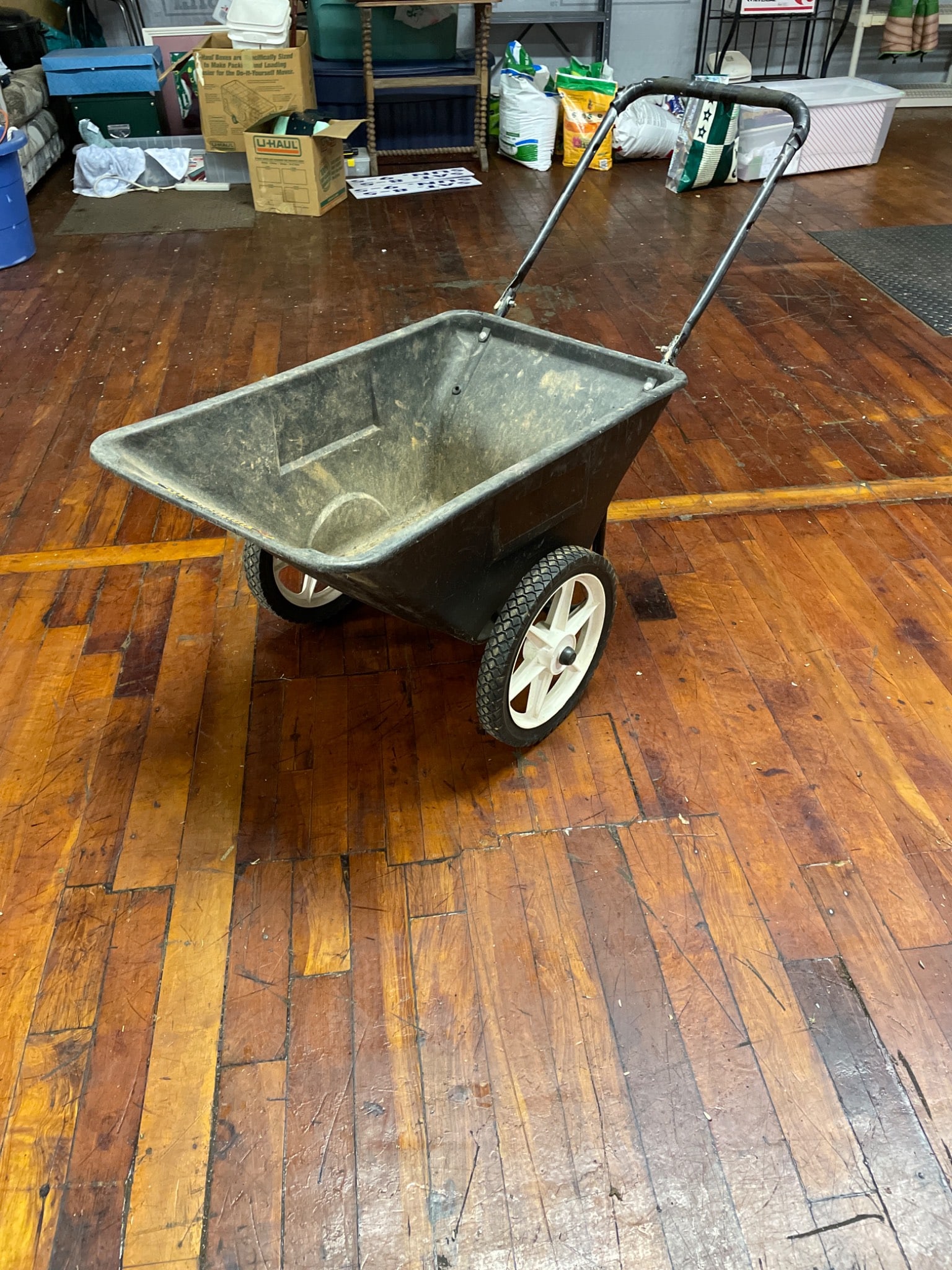 Farm & Lawn Heavy-Duty Push Spreader with Repairable Handle: Heavy-duty push spreader with two large wheels and a durable plastic hopper. Designed for spreading materials like fertilizer or seed. The handle features a known issue and requires repair, as it