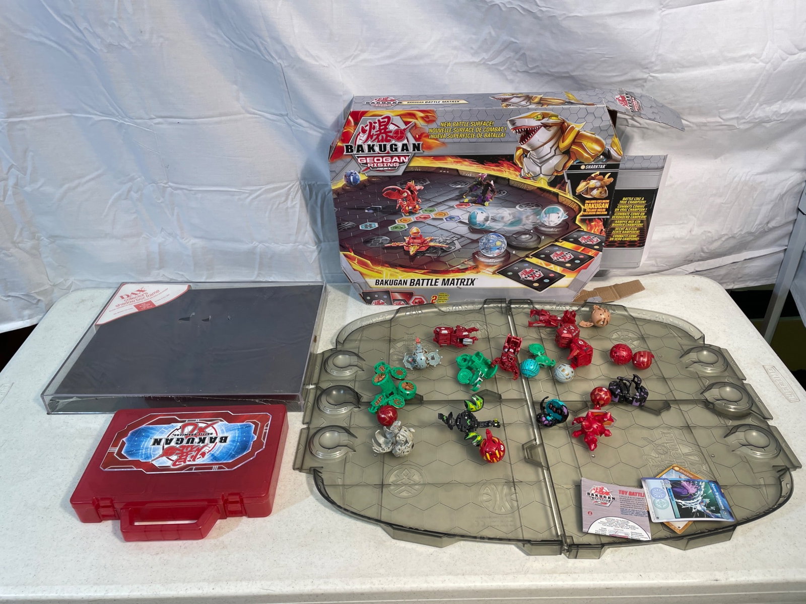 Bakugan Geogan Rising Battle Matrix with Figures and Accessories: This lot includes a Bakugan Geogan Rising Battle Matrix playset along with a variety of Bakugan figures, cards, and accessories. The set appears to include the original box, multiple Bakugan figures, 