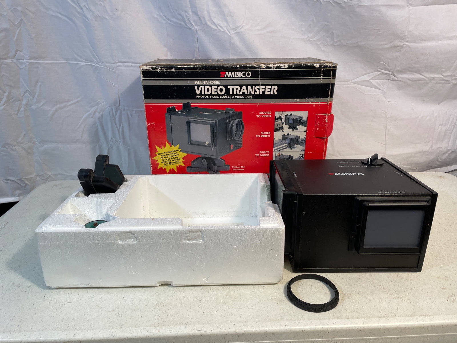 Ambico All-In-One Video Transfer Model V-0652 - For Photos, Films, Slides: Ambico All-In-One Video Transfer Model V-0652 designed for converting photos, films, and slides to video tape. The unit comes with its original packaging, foam inserts, and parts including the