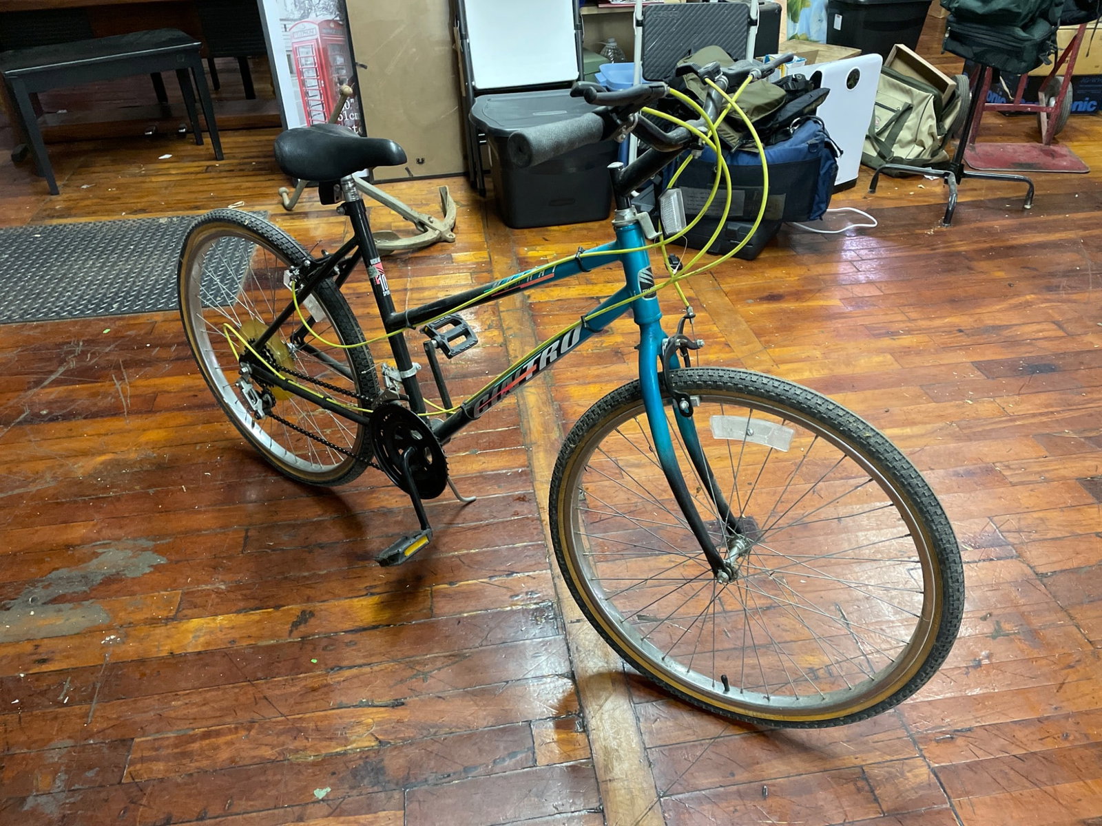 Cinero 10-Speed Bicycle With Steel Frame and Needs New Tires: A Cinero 10-speed bicycle featuring a steel frame, alloy components, and yellow cables. This bike is equipped with standard derailleur gear shifting and traditional rim brakes. The tires are not holdi