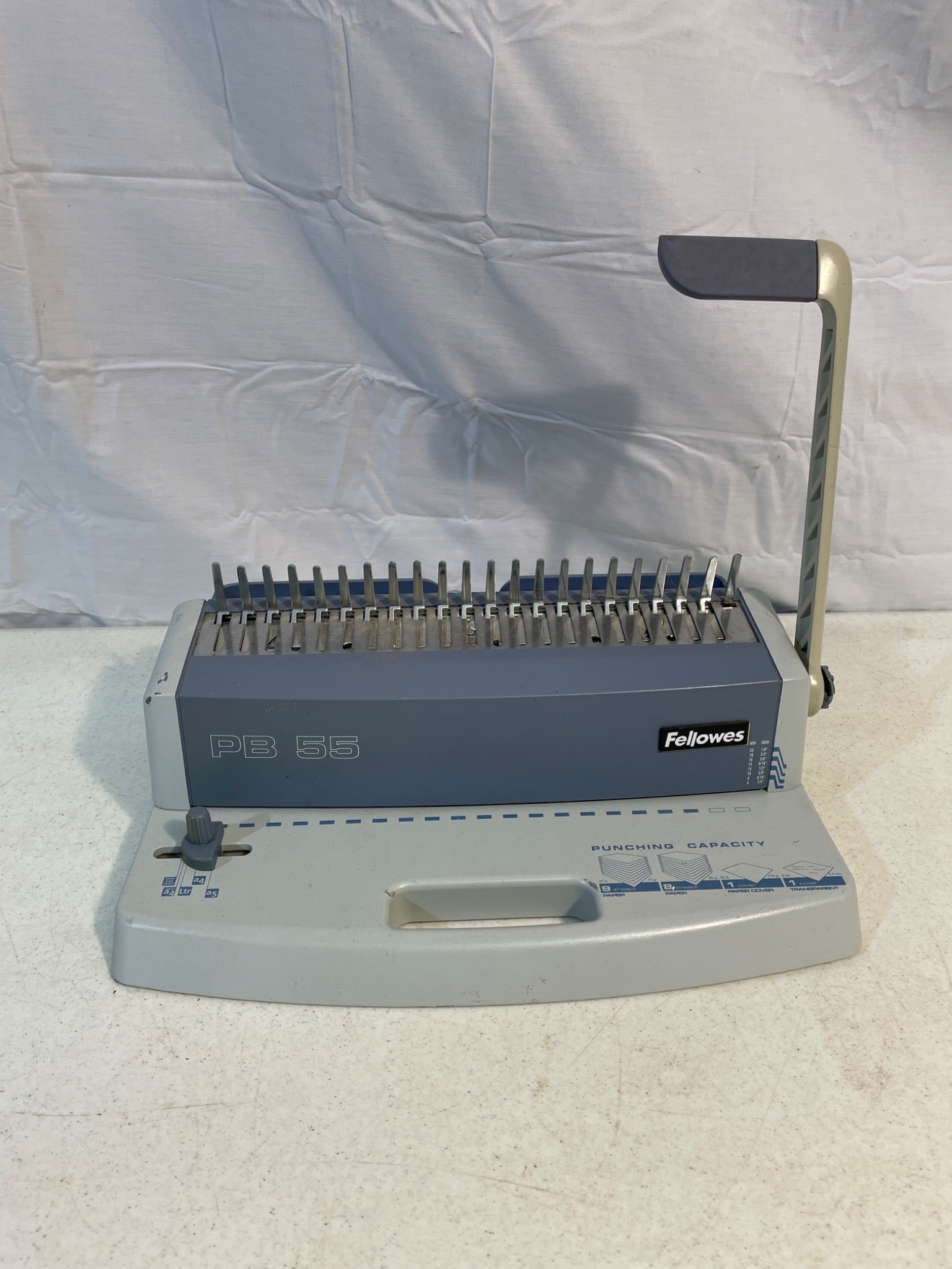 Fellowes Star+ Comb Binding Machine with Adjustable Punching Mechanism: Fellowes Star+ comb binding machine with adjustable edge guide and integrated comb storage tray. Designed for moderate use, it punches up to 15 sheets at a time and binds up to 150 sheets with a