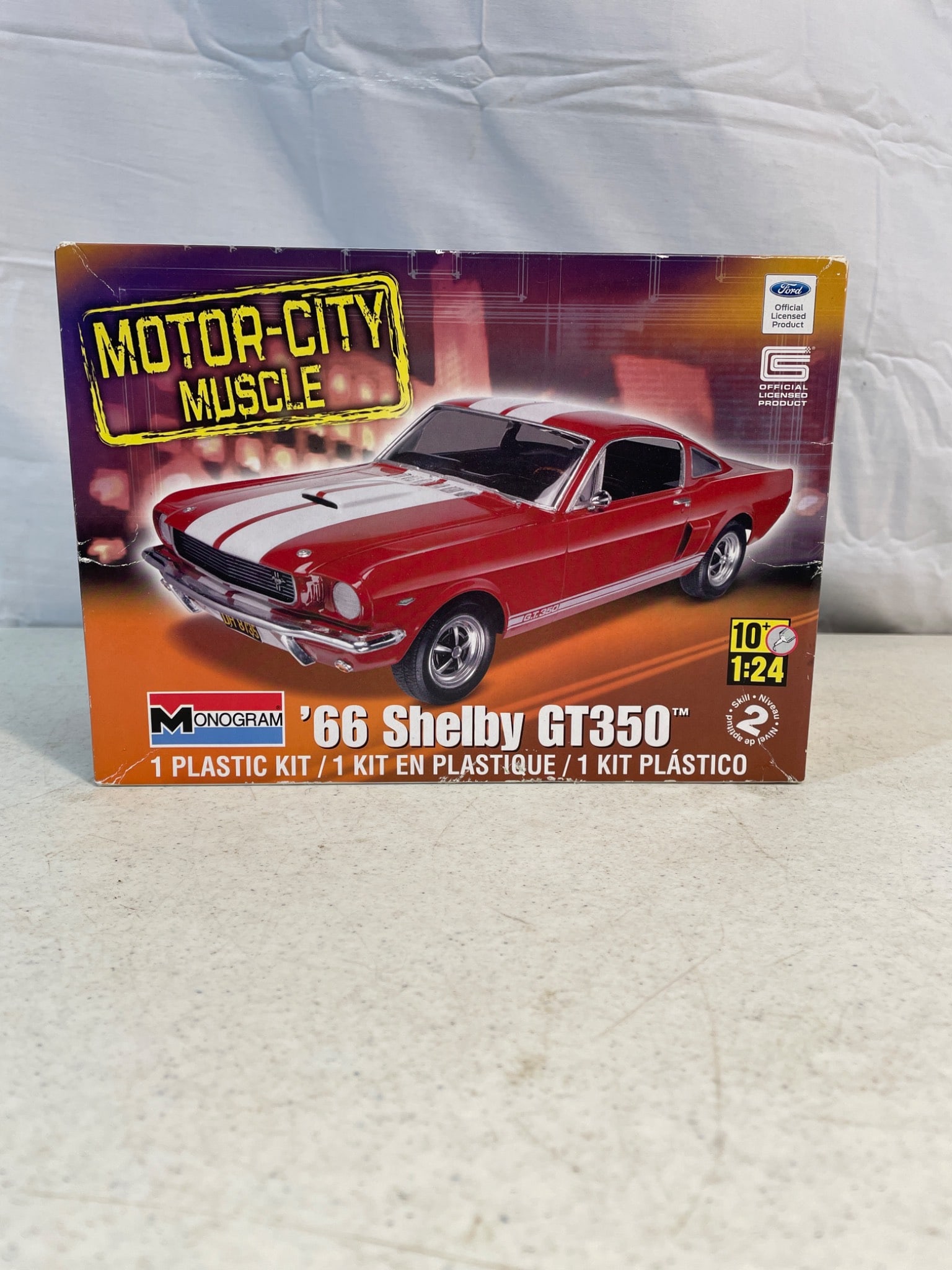 2011 Revell Monogram Motor-City Muscle '66 Shelby GT350 1:24 Model Kit: This is a 1:24 scale model kit of the 1966 Shelby GT350 by Revell, part of the Motor-City Muscle series. Manufactured in 2011 by Revell Inc., the kit includes plastic parts, decals, and assembly