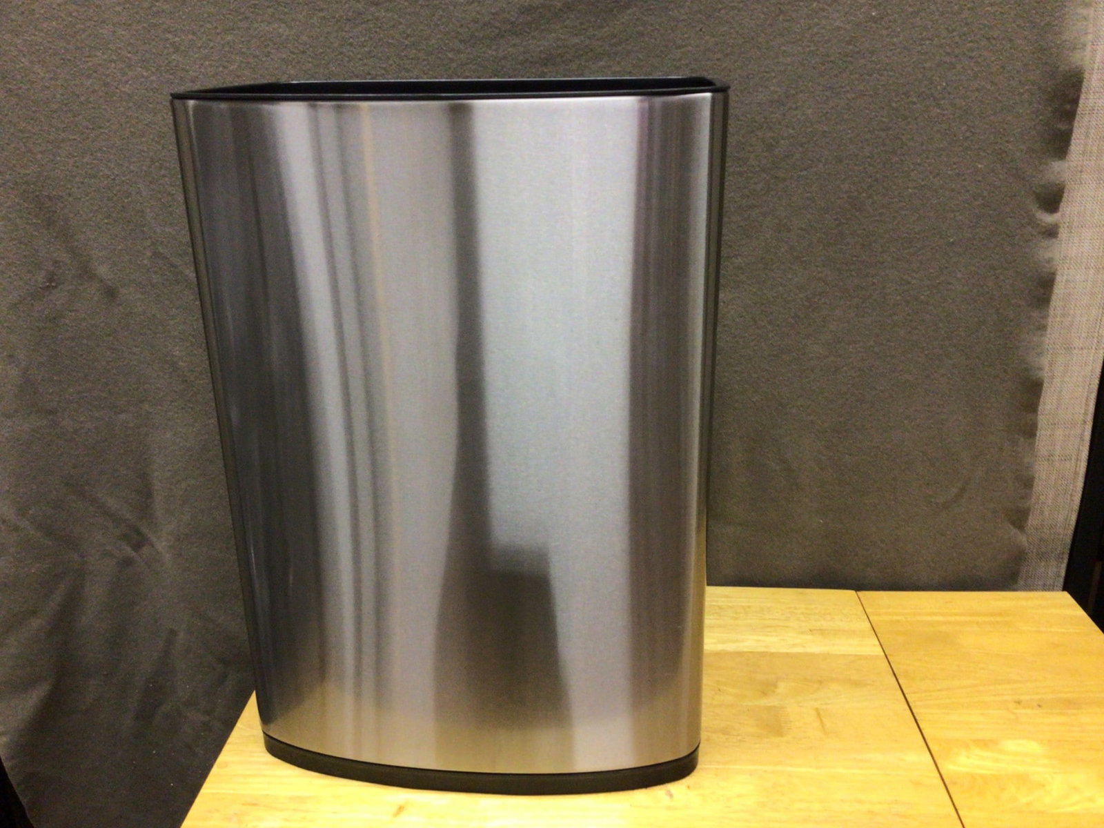 Stainless Steel Trash Can with Removable Plastic Liner: A stainless steel trash can featuring a removable plastic liner for added convenience. The bin has a clean, sleek design and includes a hole in the liner for securing trash bags. Designed for durabili