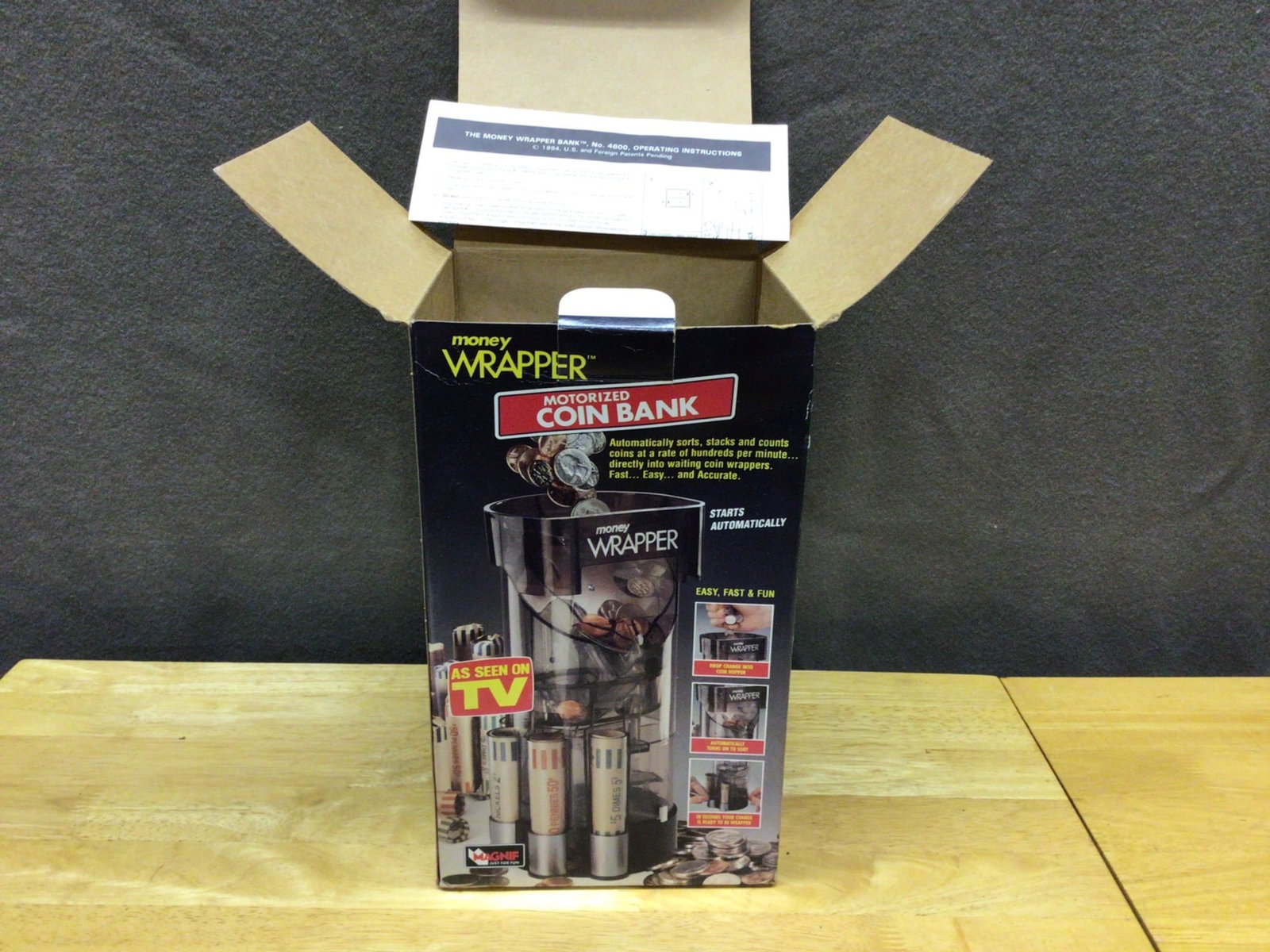 Motorized Coin Bank, Model #4960, With Original Box and Instructions: This listing features the Money Wrapper Motorized Coin Bank, Model #4960. The item includes the original box and operational instructions. It sorts, stacks, and counts coins, operating automatically