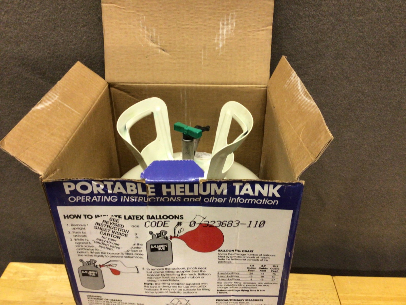 Balloon Time Portable Helium Tank for Latex Balloons: The Balloon Time Portable Helium Tank is designed for inflating latex balloons for various occasions. The tank comes in its original packaging, marked with the code 0-76523683-110. The unit is filled