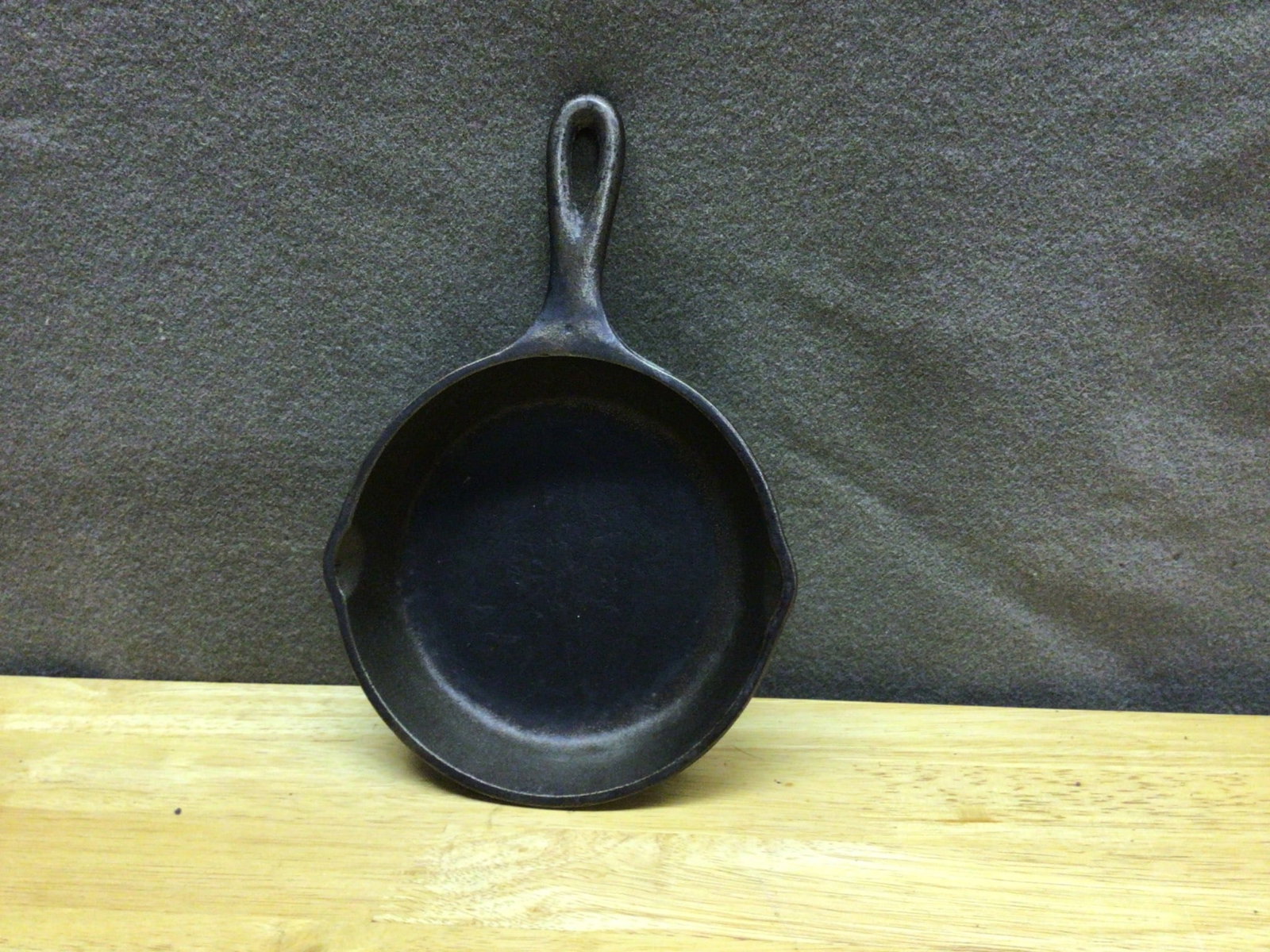 Lodge Cast Iron Skillet, 6-Inch, USA Made: Lodge cast iron skillet with a 6-inch diameter, as measured in the images. The bottom is marked with 'Lodge,' 'USA,' and '6 IN SK.' Suitable for various cooking applications. Made of durable, quality