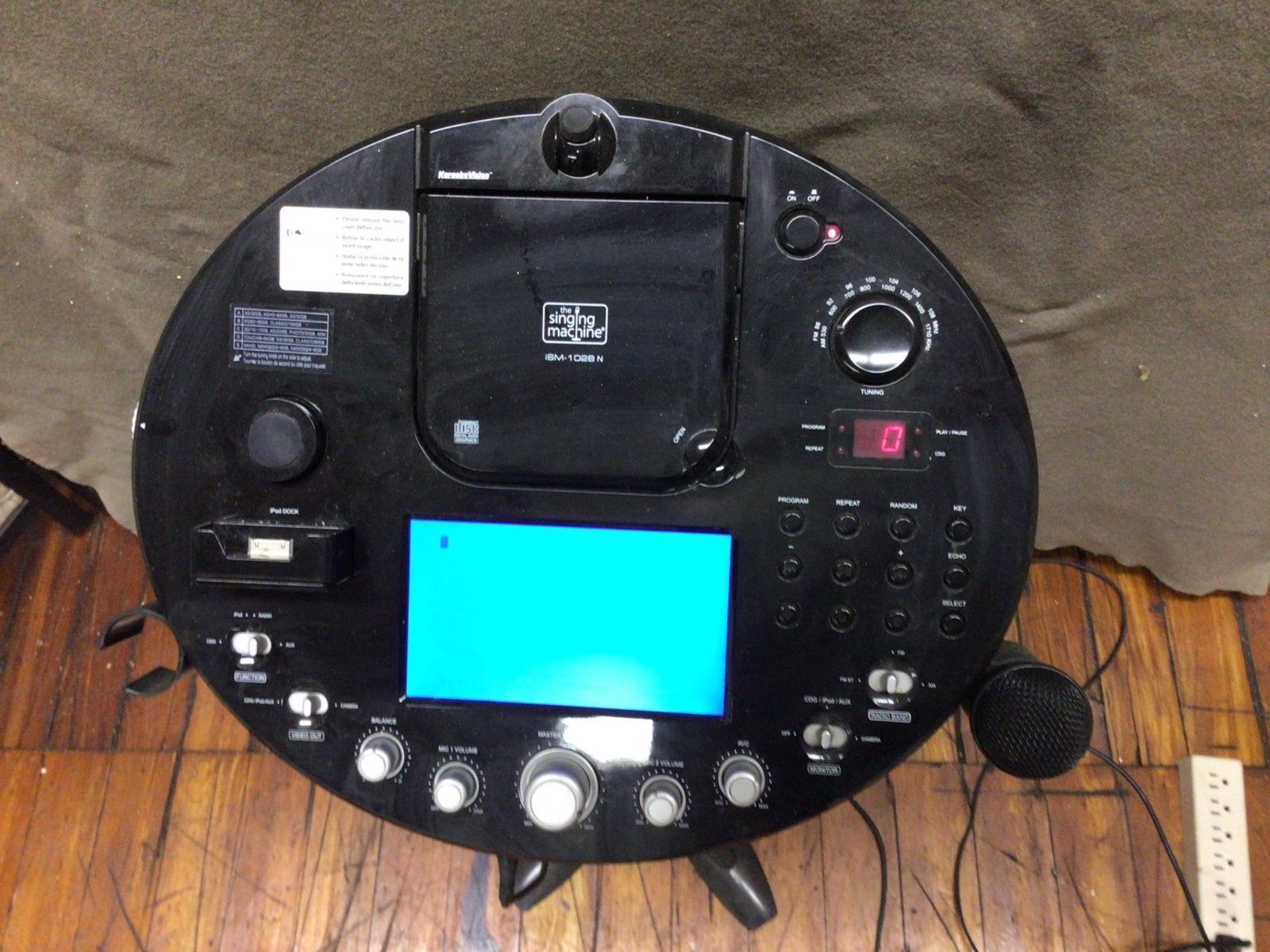 The Singing Machine ISM-1028N Pedestal Karaoke System With Display and Microphone: The Singing Machine ISM-1028N pedestal karaoke system includes a CD+G player, 7-inch color TFT display, and microphone. Features multiple control knobs for volume, echo, and balance along with