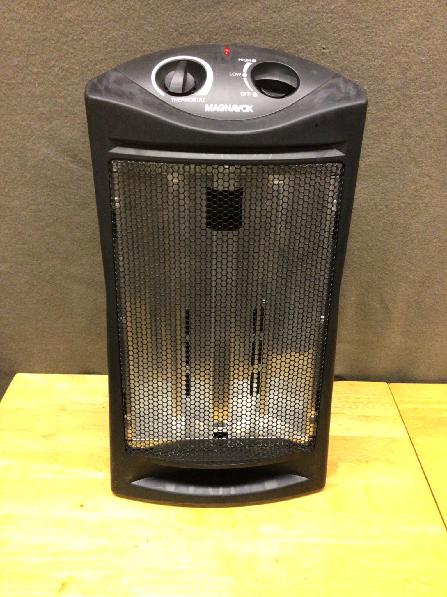 Magnavox Electric Heater With Adjustable Thermostat: This is a Magnavox electric heater featuring an adjustable thermostat and fan settings for Low, High, and Oscillation. The back label indicates compliance with safety standards and lists the model