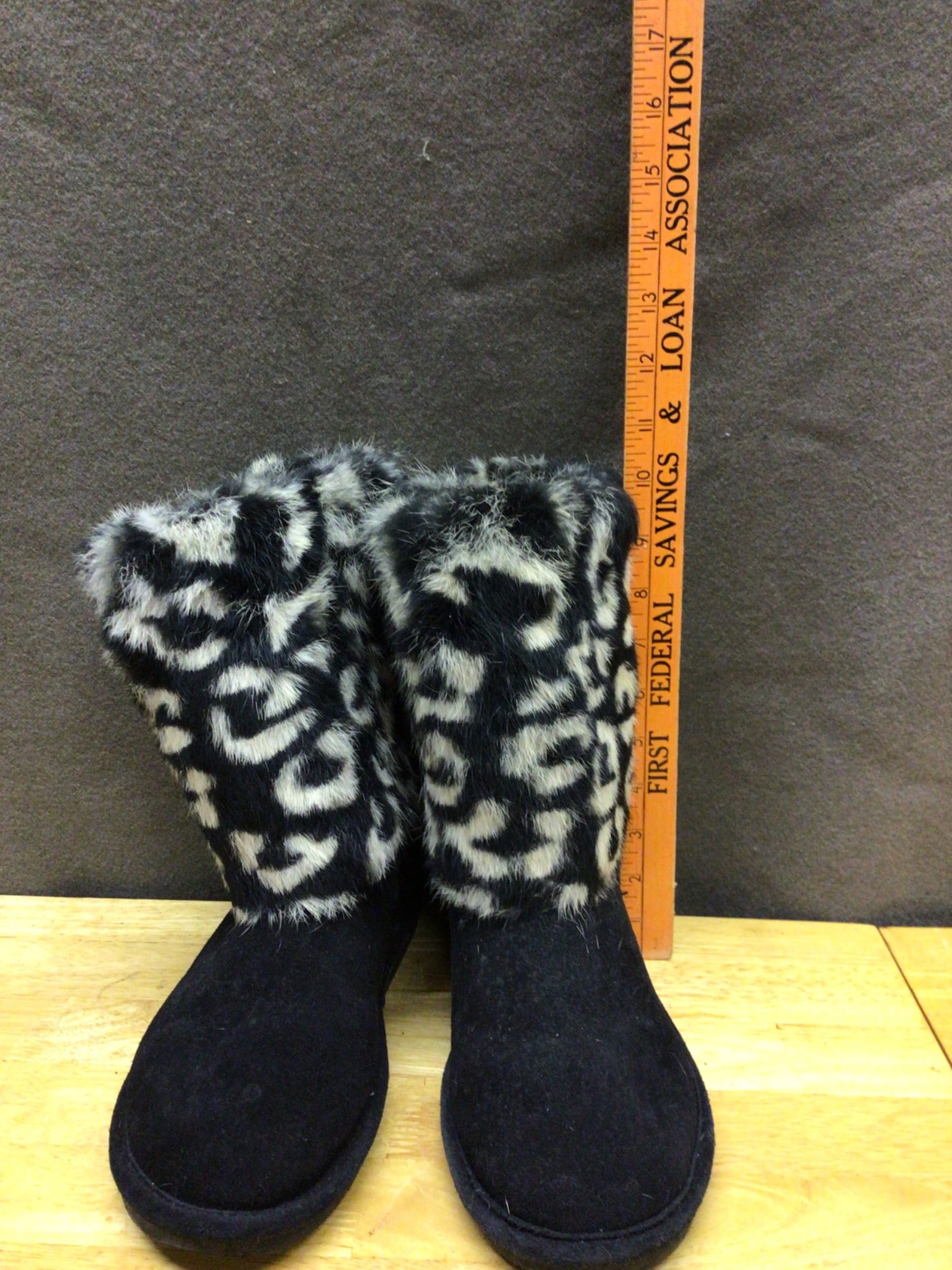 Women's Size 10 Faux Fur and Suede Boots with Rubber Sole: Women's boots in size 10 featuring a faux fur upper with a black and white animal print design. The main body is constructed from black suede-like material, and the sole is made of rubber with a