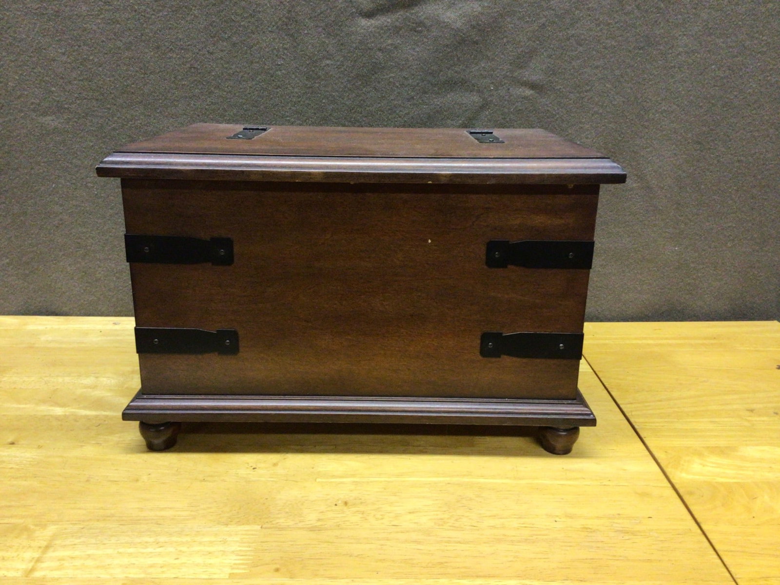 Wooden Jewelry Organizer With Mirror and Multiple Compartments: Wooden jewelry organizer featuring a flip-top lid with inset mirror, metal hinges, and decorative iron strap accents. Includes removable compartmentalized trays with spaces for rings and small