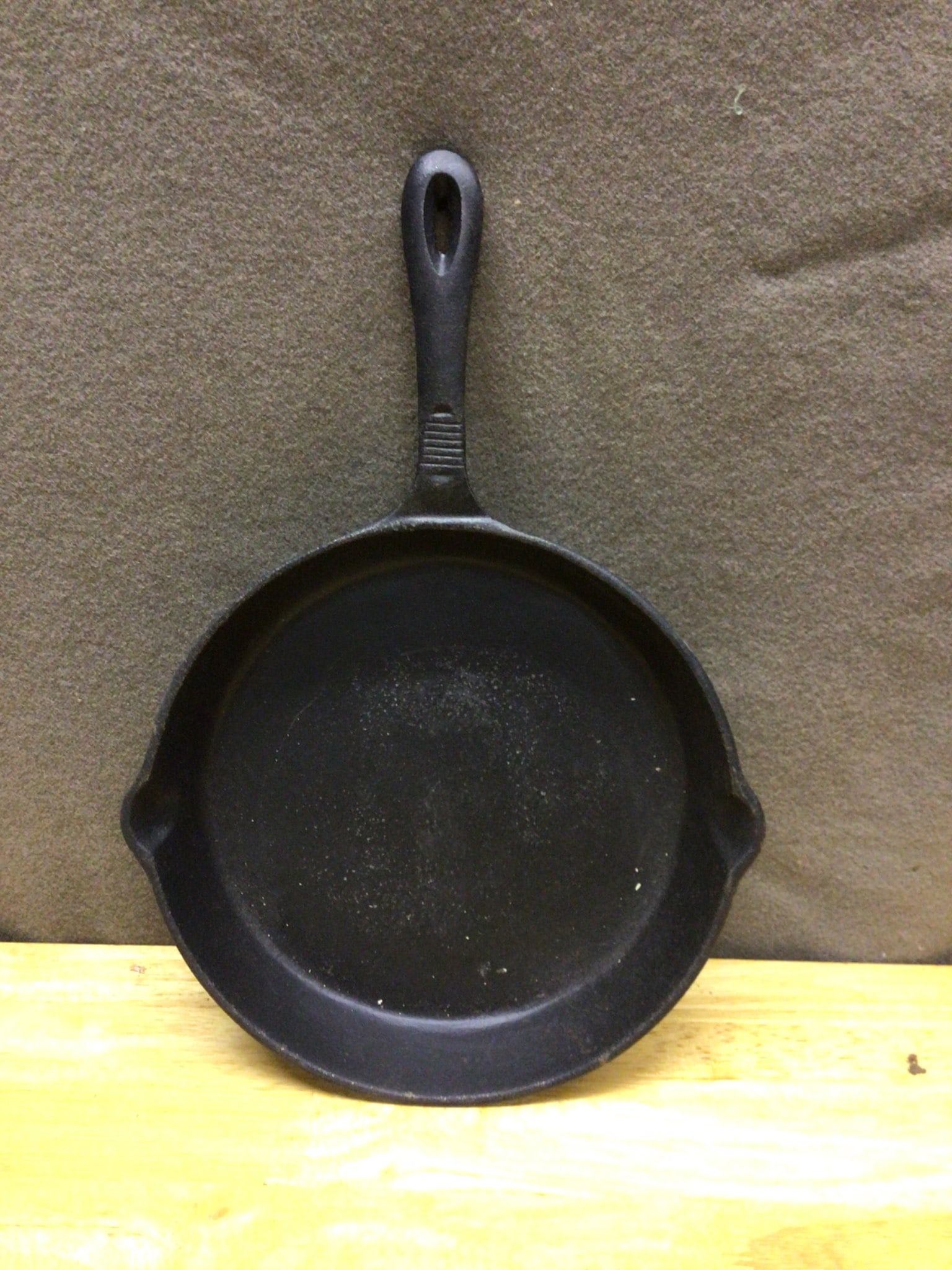 Henck Classics Cast Iron Skillet with Handle and Pour Spouts: Henck Classics cast iron skillet with molded handles and dual pour spouts. Bottom of the skillet stamped with 'Henck CLASSICS.' Estimated diameter approximately 10 inches, as measured across the top. 
