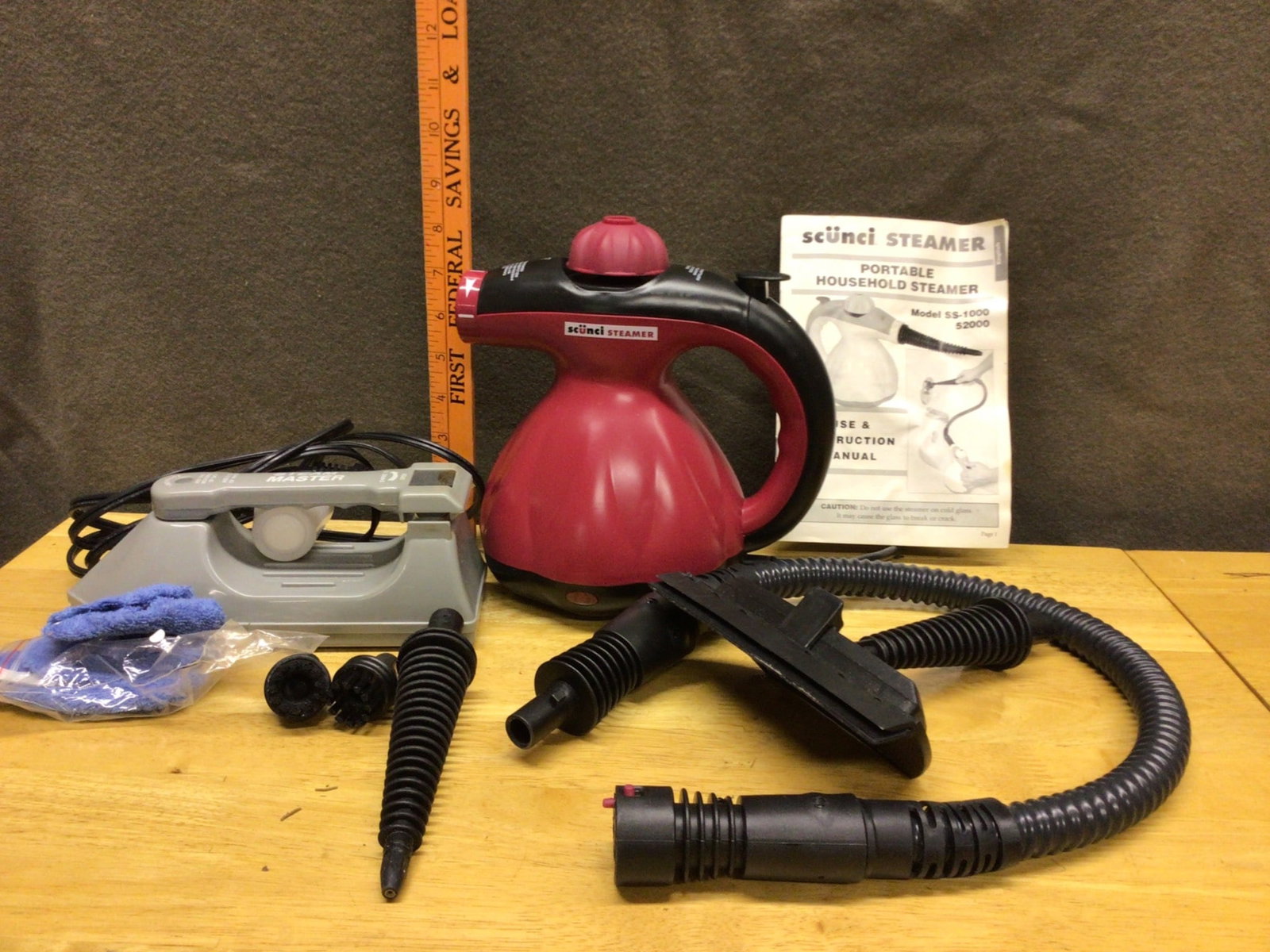 Scunci Steamer Model SS-1000 Portable Household Steamer With Accessories: Scunci Steamer Model SS-1000, comes with portable household steamer unit, user manual, and accessories. Includes hose attachments, nozzle tips, and additional tools. Designed for versatile steaming ta