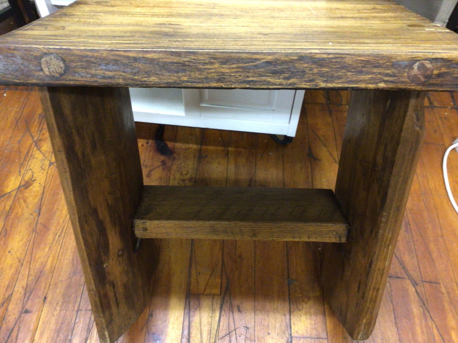 Handmade Wooden Table, 2 ft. Tall and 2 ft. Long: Solid handmade wooden table with a rectangular top, measuring approximately 2 feet in height and 2 feet in length. Constructed from thick, heavy wood, the table features visible imperfections consiste