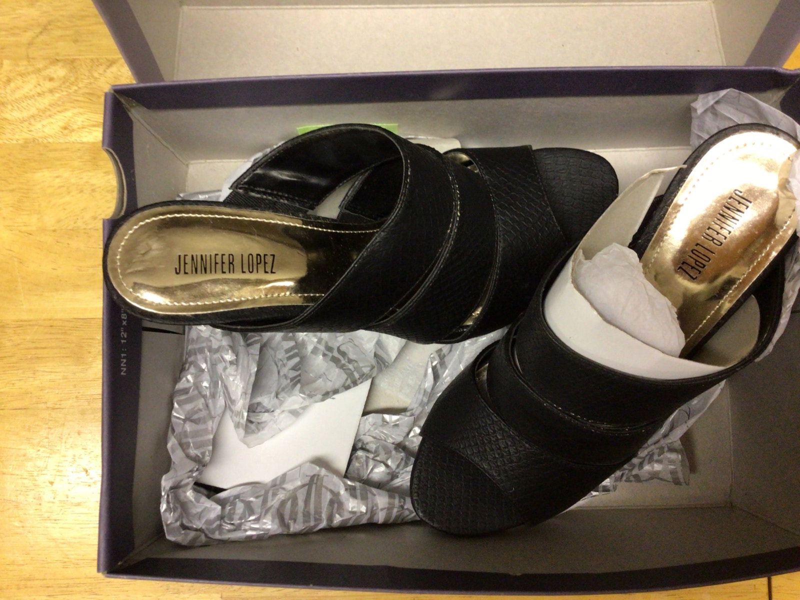 Jennifer Lopez Women's Black Sandals with Gold Accents, Size 7 Medium: Jennifer Lopez brand women's sandals in black with gold accents. Size 7 medium. Made in China with all man-made materials. Includes original box. Model identification: JLORELLE BLK, UPC: 400993918378.