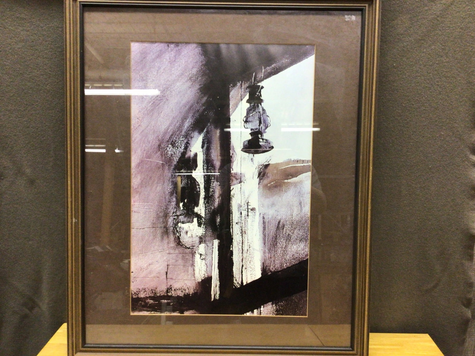 Framed Abstract Artwork With Lantern Theme: This is a framed abstract artwork featuring a lantern. The artwork measures approximately 32 inches in height and 24 inches in width, including the frame. It is housed in a dark wooden frame with a br