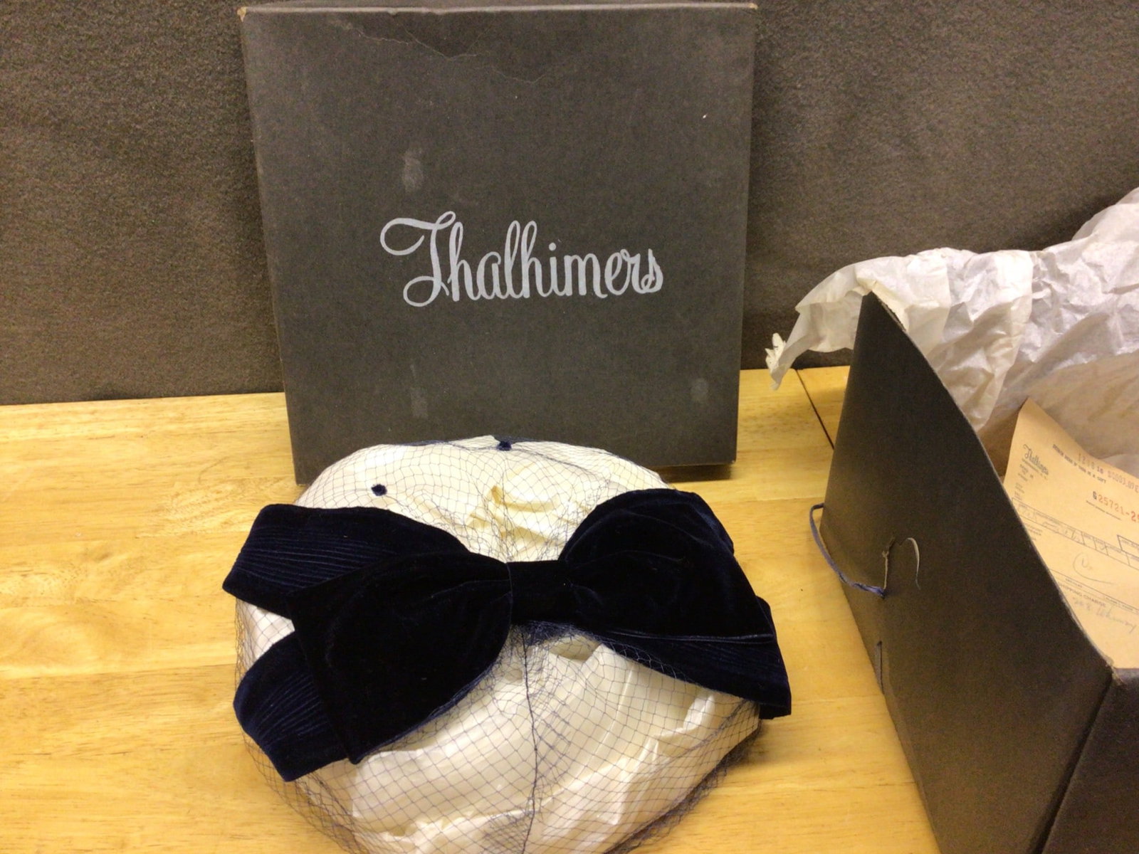 Thalhimers Hat with Box and Receipt, Featuring Velvet Bow and Netting: This lot includes a hat from Thalhimers with accompanying original box and receipt. The hat is adorned with a velvet bow and netting and appears to retain original packaging materials. The attached re