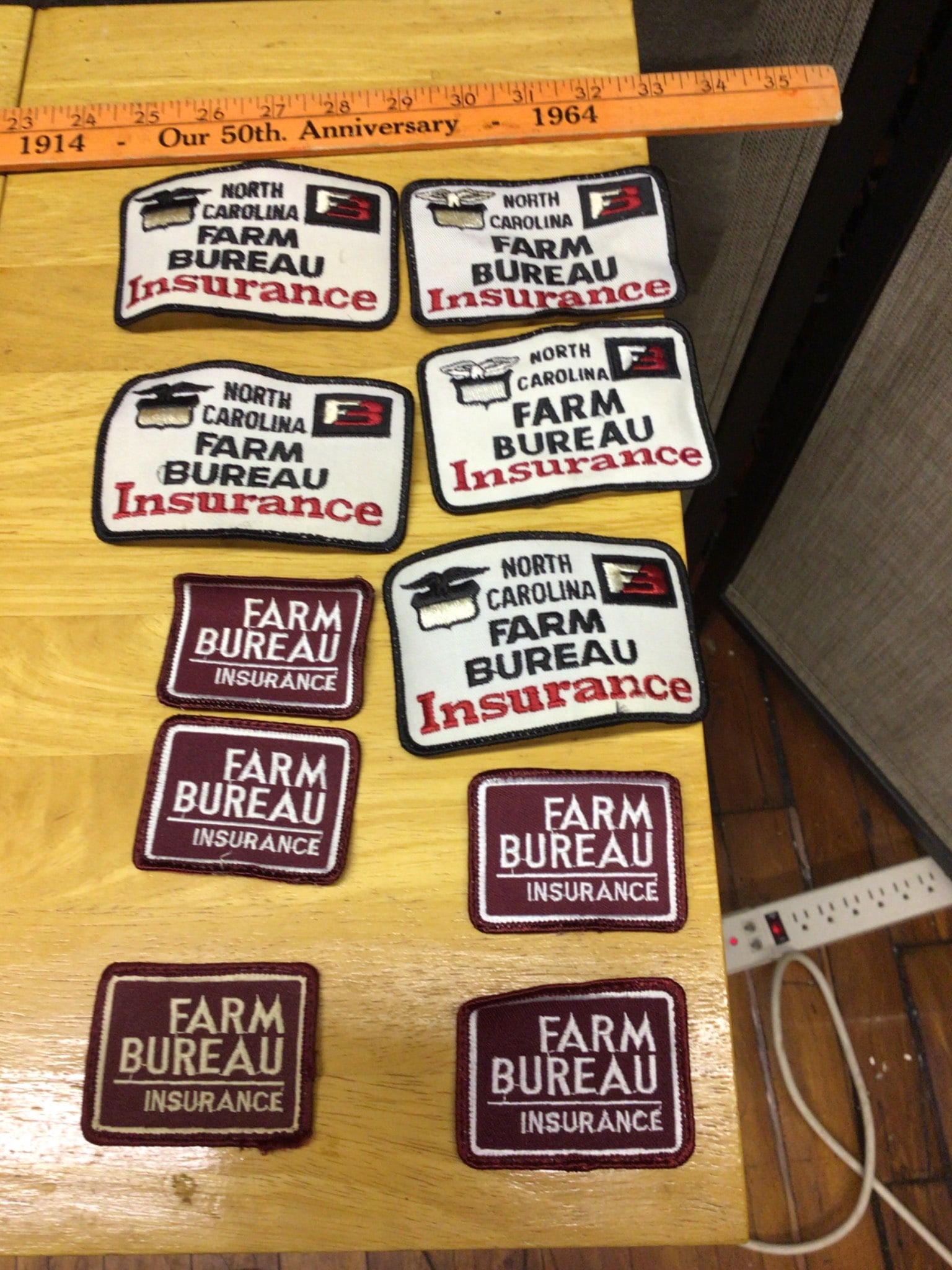 10 Farm Bureau Insurance Promotional Patches: This lot includes 10 embroidered patches featuring designs from Farm Bureau Insurance, including North Carolina. The set contains both white and maroon variations, as shown in photos. Each patch