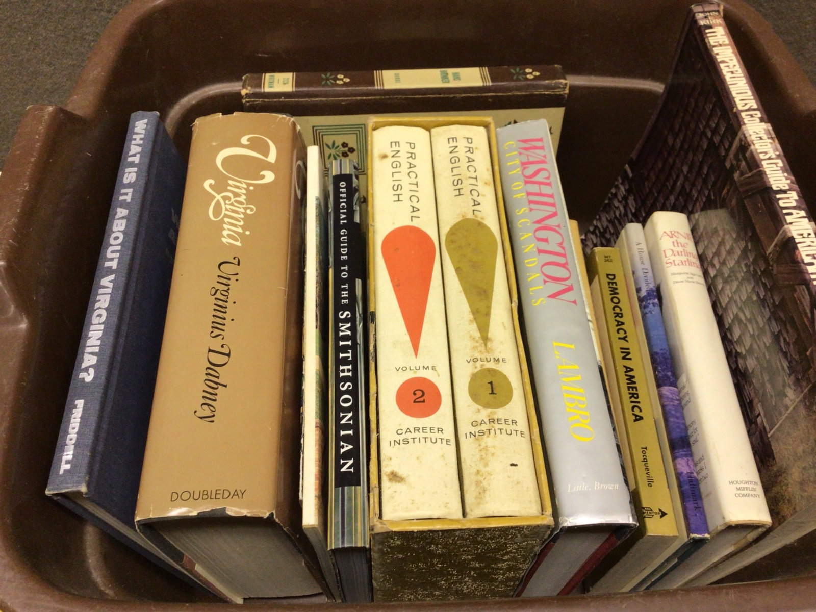 Hardcover and Paperback Books on History, Language, and Culture: Books including titles such as 'What is It About Virginia?', 'Official Guide to the Smithsonian', 'Practical English Volumes 1 and 2', 'Washington', 'Democracy in America', and 'The Killer Angels'.