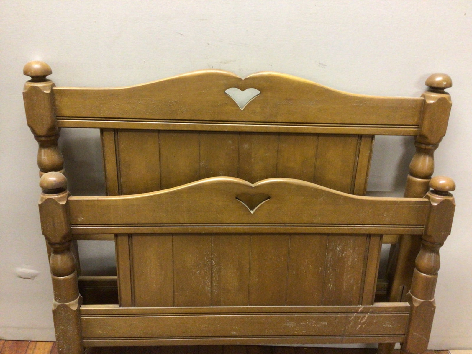 Wooden Twin Bed Frame with Heart Accents, 40 Inches Long: This twin bed frame includes a headboard and footboard made of wood. The headboard measures 37 inches tall by 40 inches long, and the footboard measures 29 inches tall by 40 inches long. Features