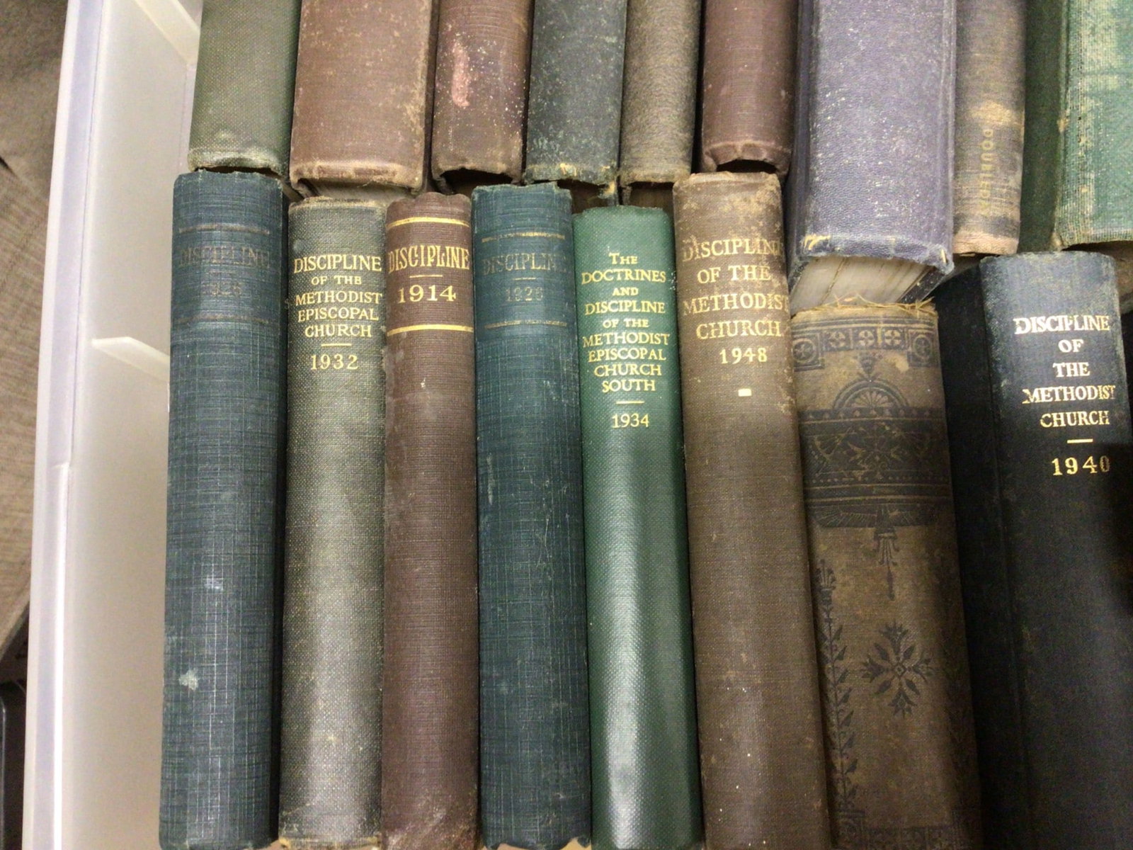 Box Lot of Religious and Church Historical Books Spanning 1908-1976: This lot comprises a collection of religious books, primarily focusing on Methodist Church materials, including titles such as 'Discipline of the Methodist Episcopal Church' (various years including 1
