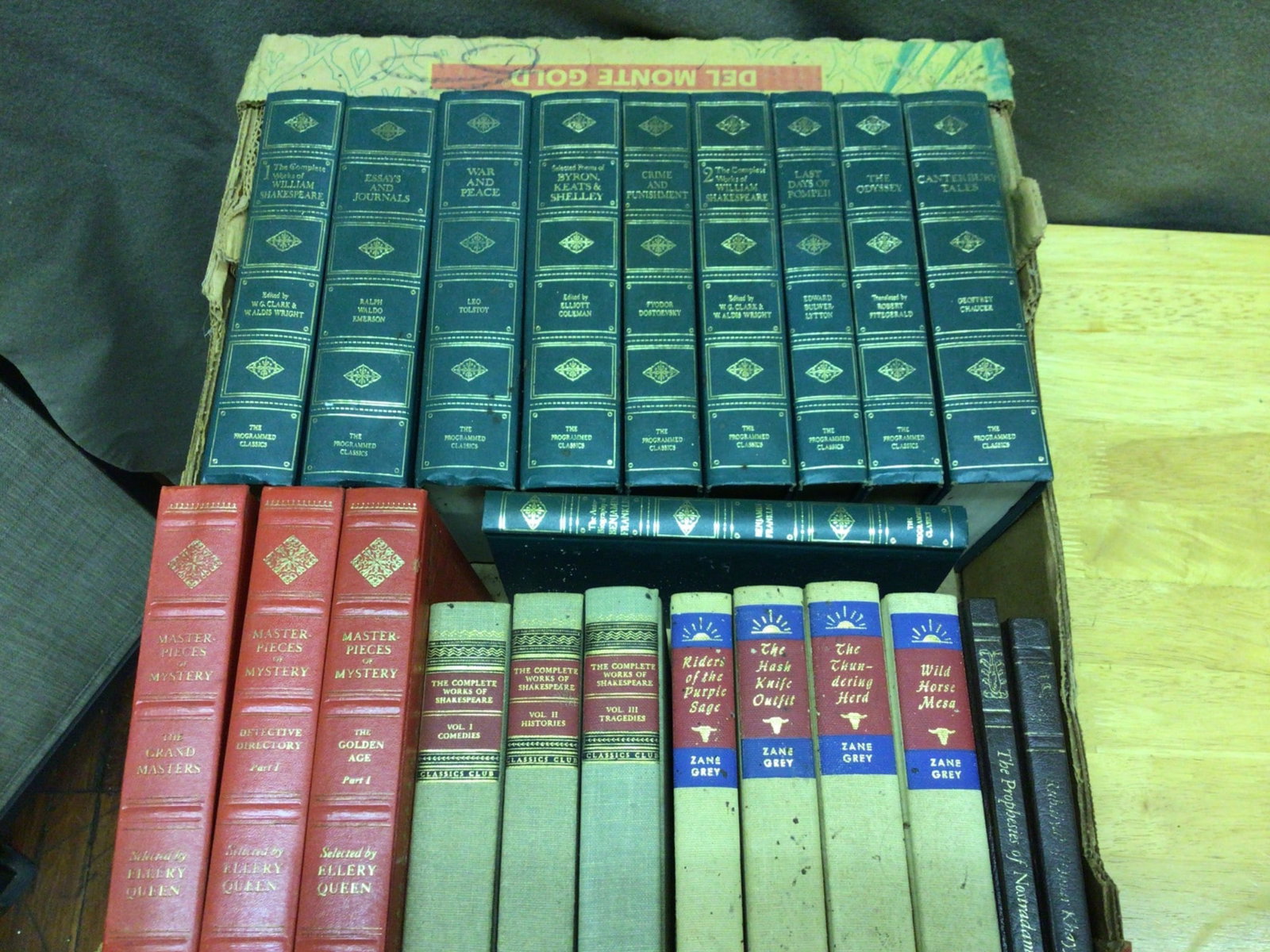 Literature and Classics with Faux-Leather and Cloth Bindings: This lot includes a boxed set of 'The Programmed Classics' featuring Shakespeare, Tolstoy, Dostoevsky, Homer, and more, bound in green faux-leather with gold stamping, three 'Masterpieces of Mystery' 