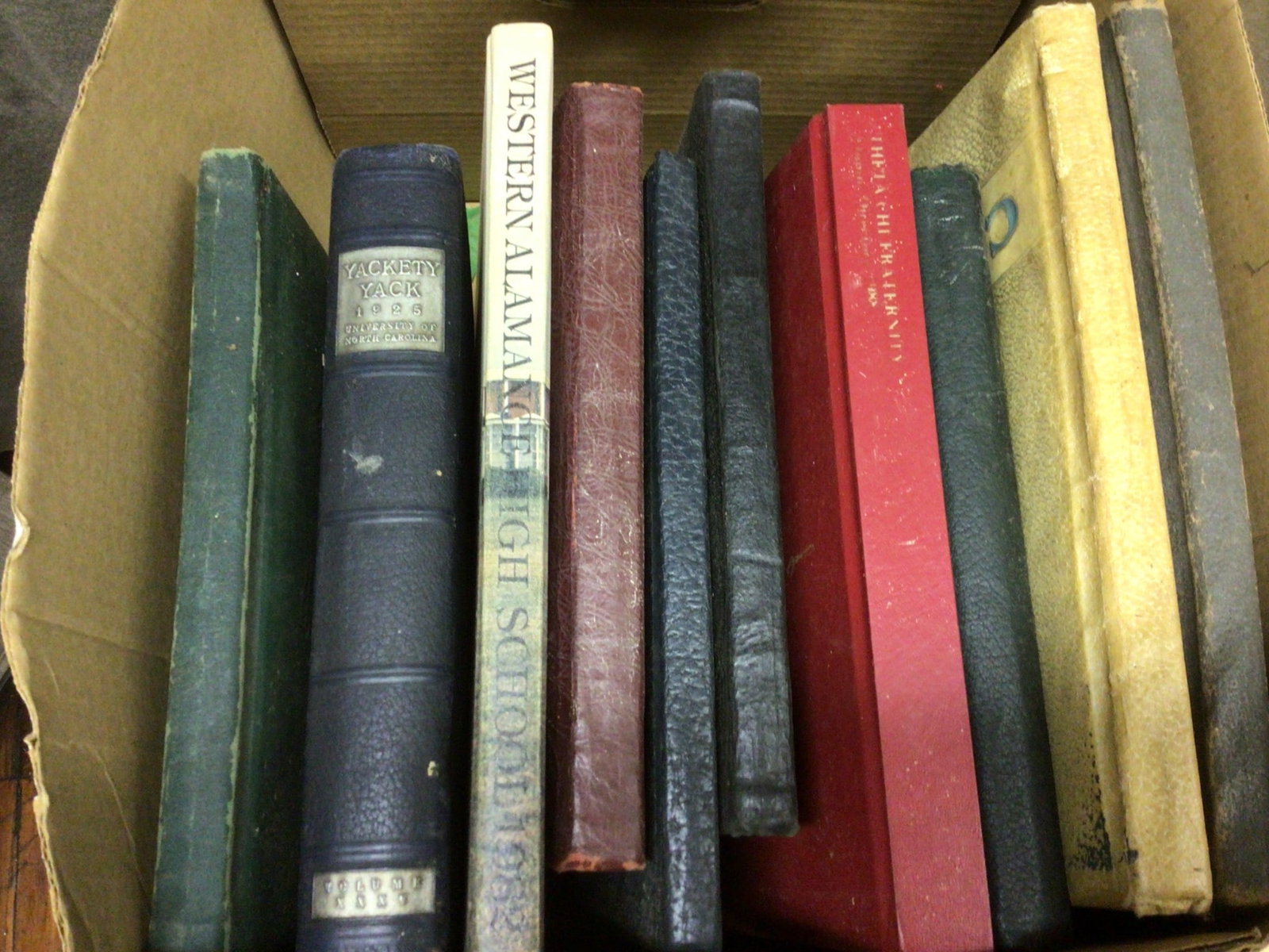 Yearbooks and Alumni Directories, Various Years: Yearbooks and directories spanning various institutions and years. Highlights include 'Pine Needles 1928', 'Yackety Yack 1925' from the University of North Carolina, multiple editions of 'Cocoon'