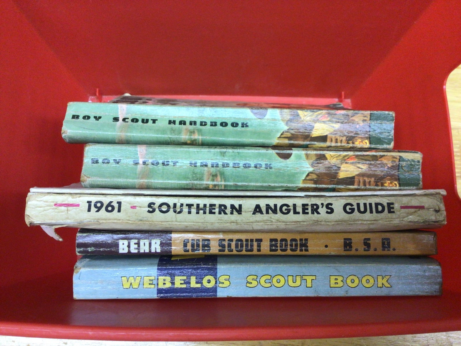 Boy Scouts Books and 1961 Southern Angler's Guide: Collection includes two Boy Scout Handbooks, 1961 Southern Angler's Guide by Don Fuelsch, Bear Cub Scout Book, and Webelos Scout Book. The books appear to be from various years and are in used conditi