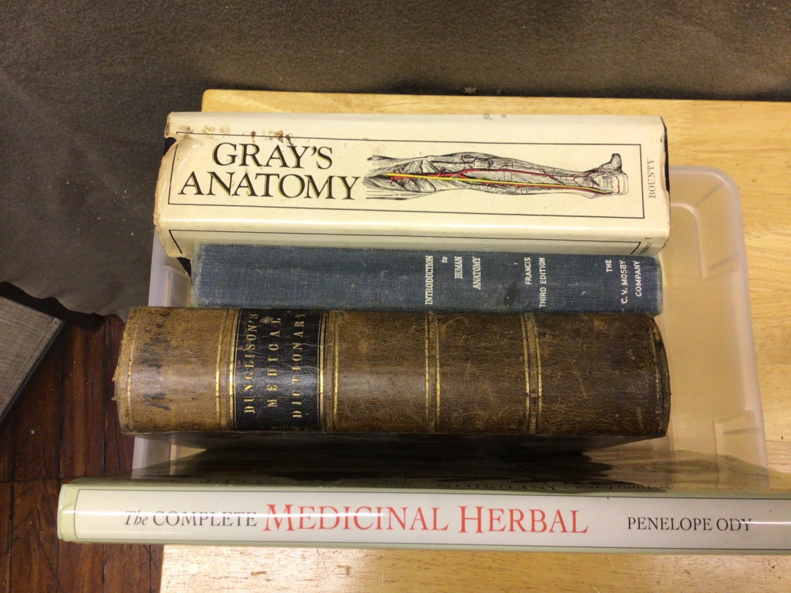Four Medical and Herbal Reference Books Including 'Gray's Anatomy': This lot includes four reference books: 'Gray's Anatomy,' hardcover, later edition; 'Dunglison's Medical Dictionary,' hardcover, vintage edition; 'Introduction to Human Anatomy' by Francis, third